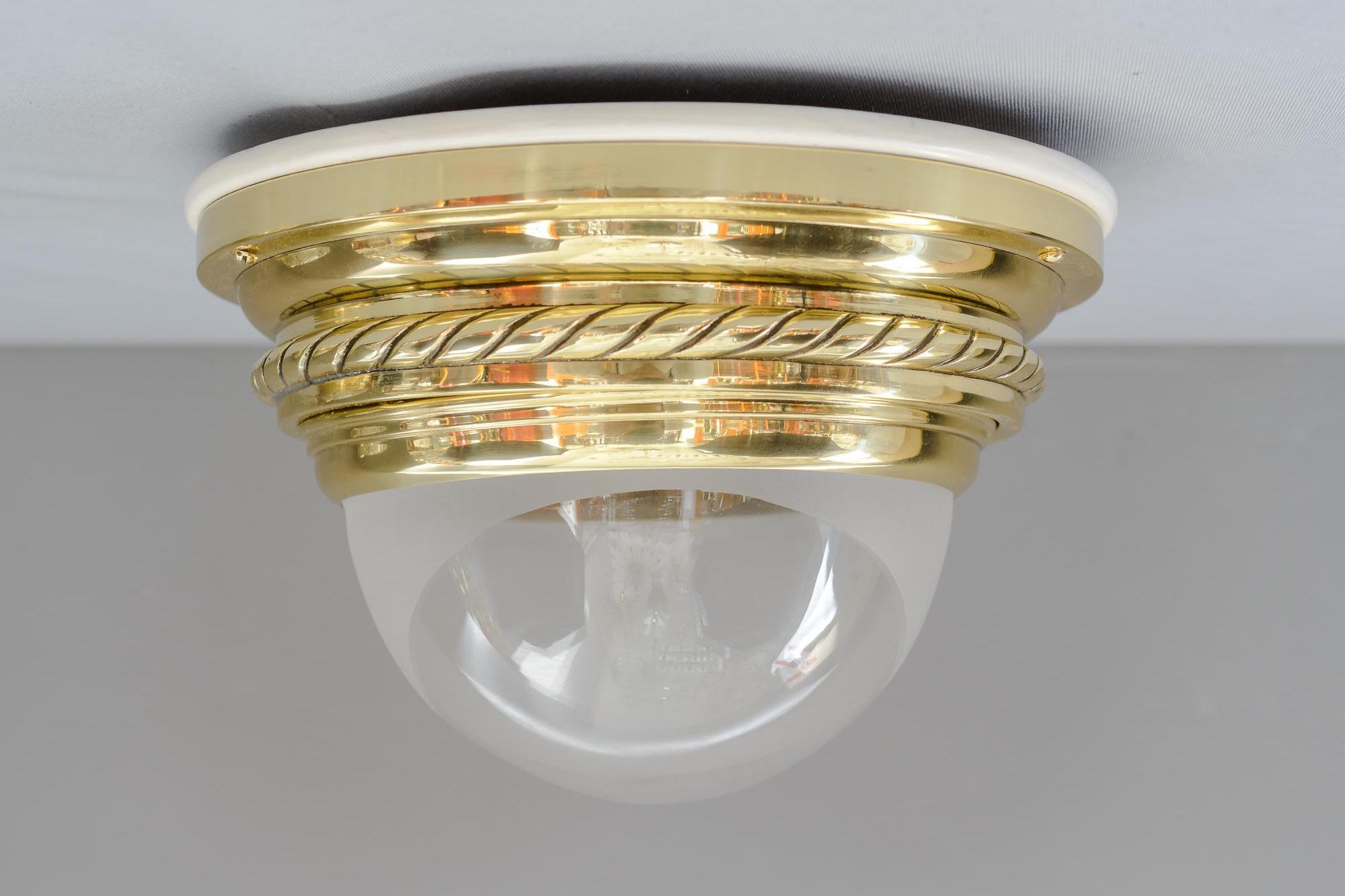 Art Deco ceiling lamp with original glass shade, Vienna, circa 1920s
Original matte partly clear glass shade
Brass parts of the lamp polished and stove enameled
Wood plate on the top is painted white.