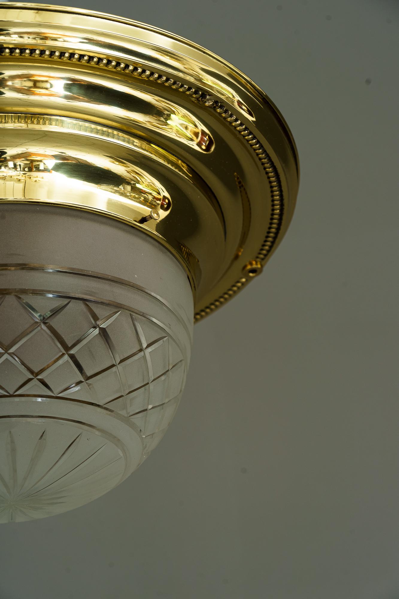 Art Deco ceiling lamp with original glass shade vienna around 1920s
Brass polished and stove enameled.
 