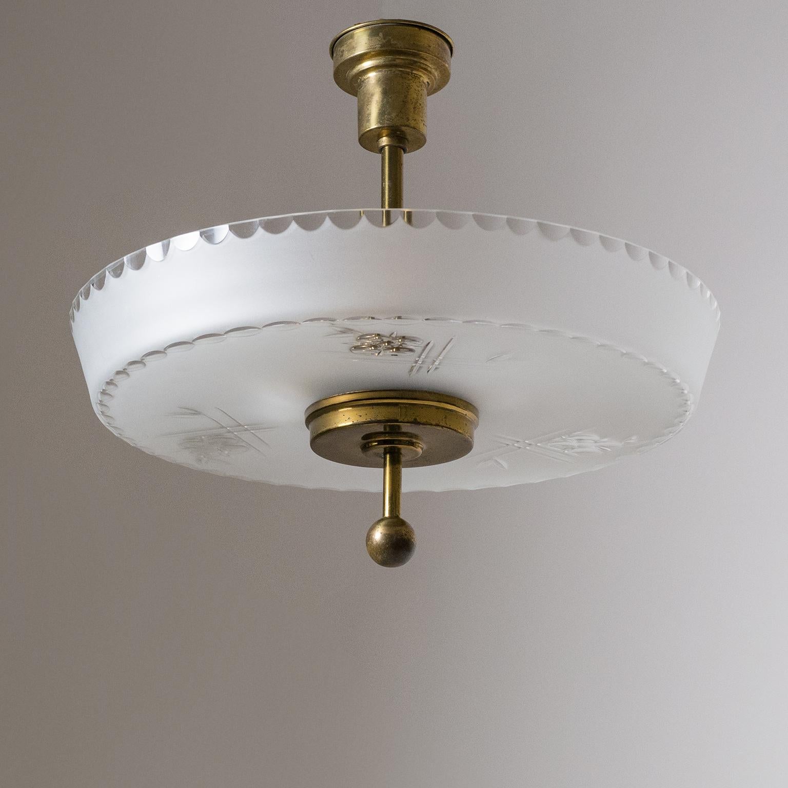 Rare Art Deco ceiling light, circa 1930. Attached to all-brass hardware is a large blown glass diffuser with a satin finish and clear cut ornamentation. Very nice original condition with a nicely aged patina on the brass. Two original brass E27
