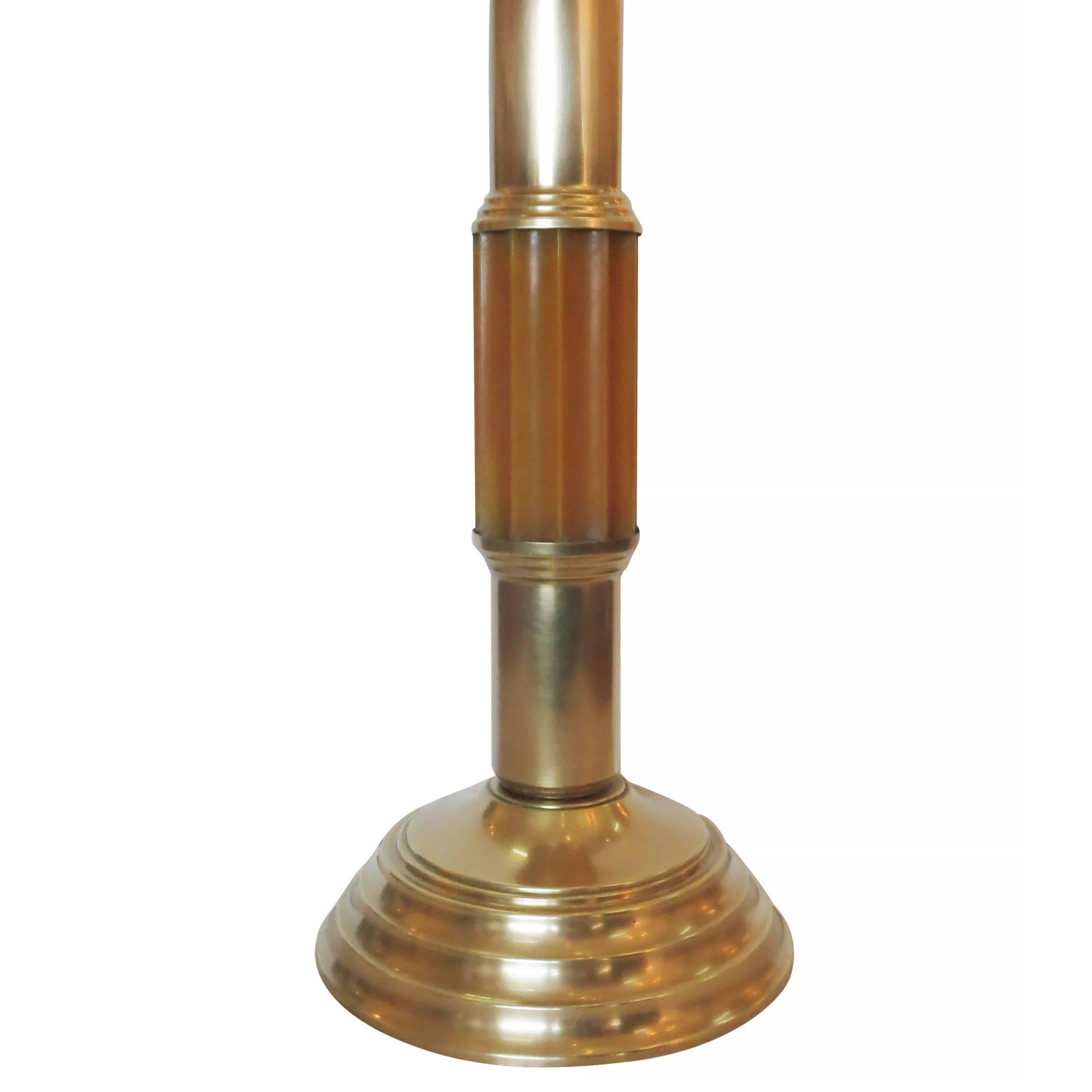 Art Deco celluloid and brass table lamp with stepped brass base and stem. The center column is made of a solid ribbed piece of celluloid.