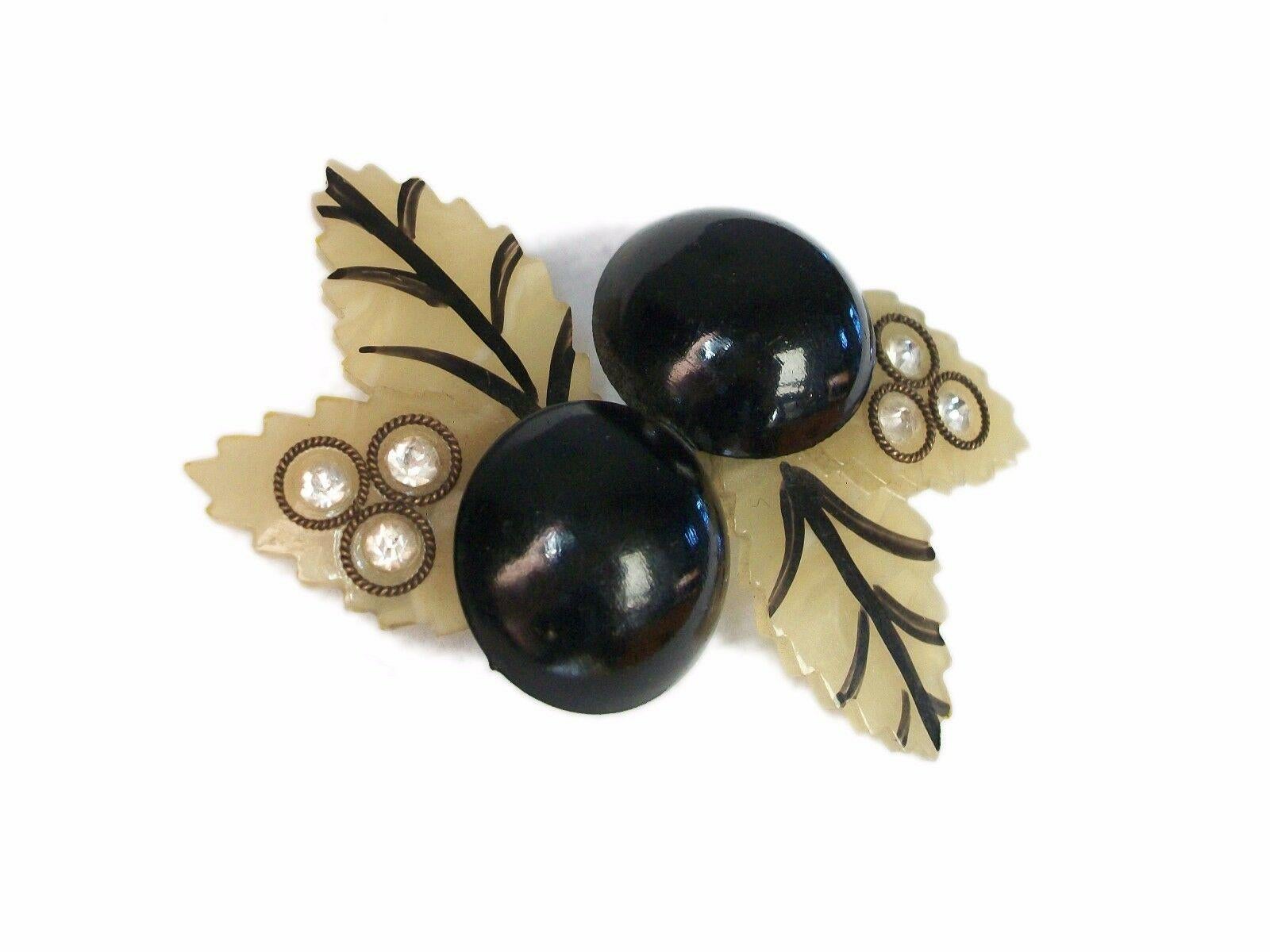 Art Deco celluloid 'black cherry' brooch/pin - two leaves with painted veins - the other two leaves set with rhinestones and twisted brass surrounds - original 'c' catch and long pin with round hinge - unsigned - United States (likely) - circa
