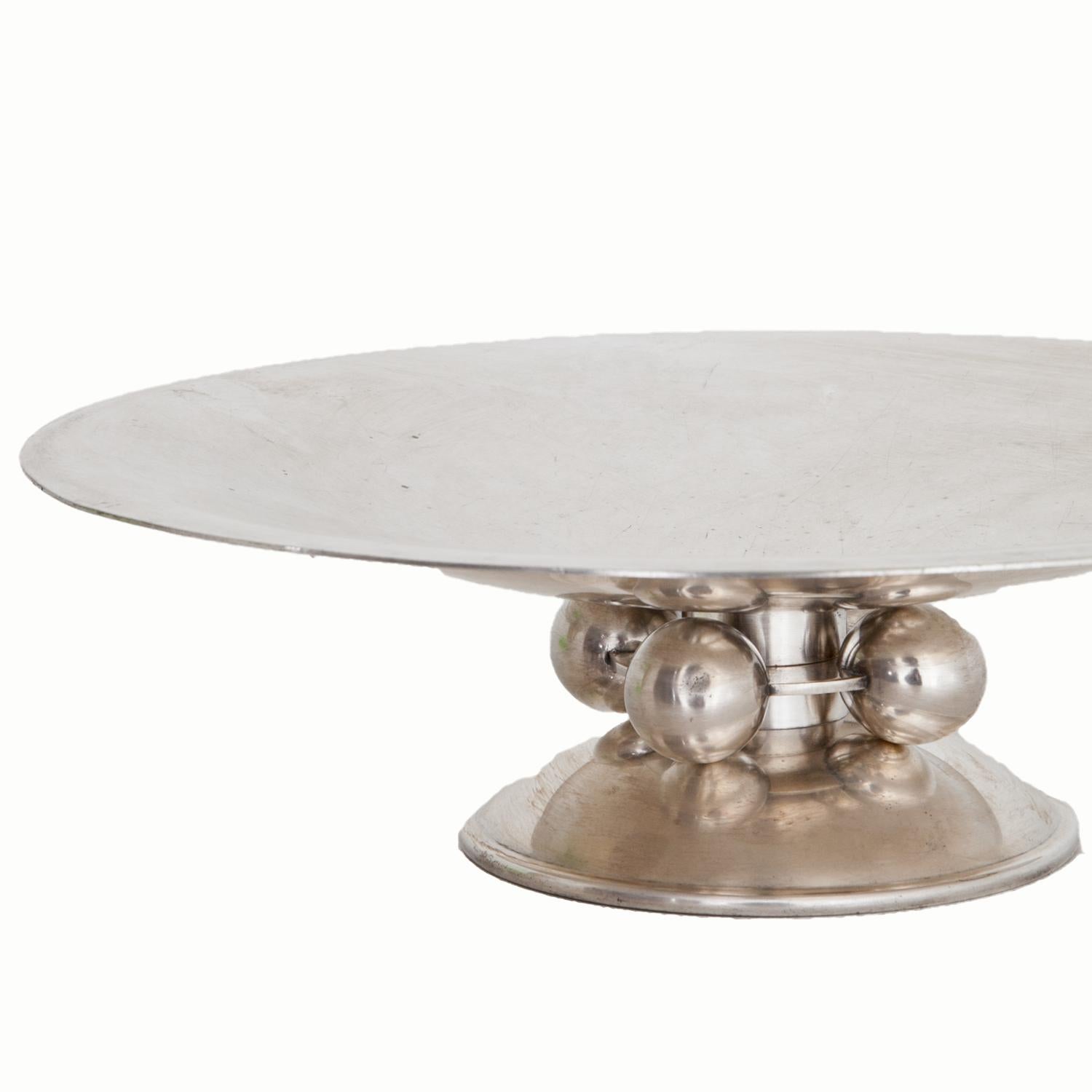Silvered fruit bowl on a round stand with four sphere ornaments and a shallow well. Marked on the bottom Christofle. Condition B.