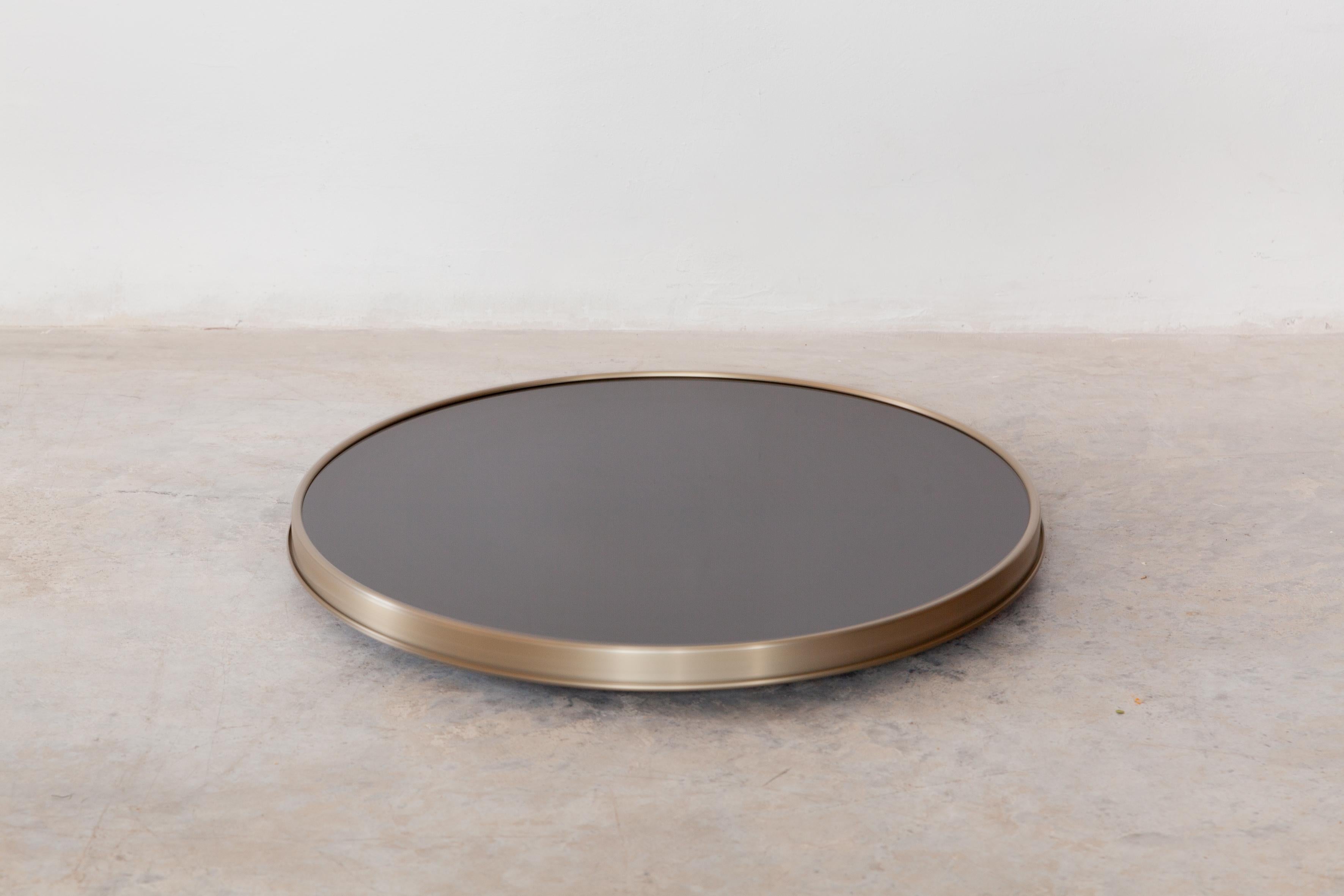 Tray shaped round silver plated cocktail tray with black glasstop, bottom retained by four brackets, lined with a wooden floor.
This is a wonderful piece of modernist design. In good condition - slight surface wear.