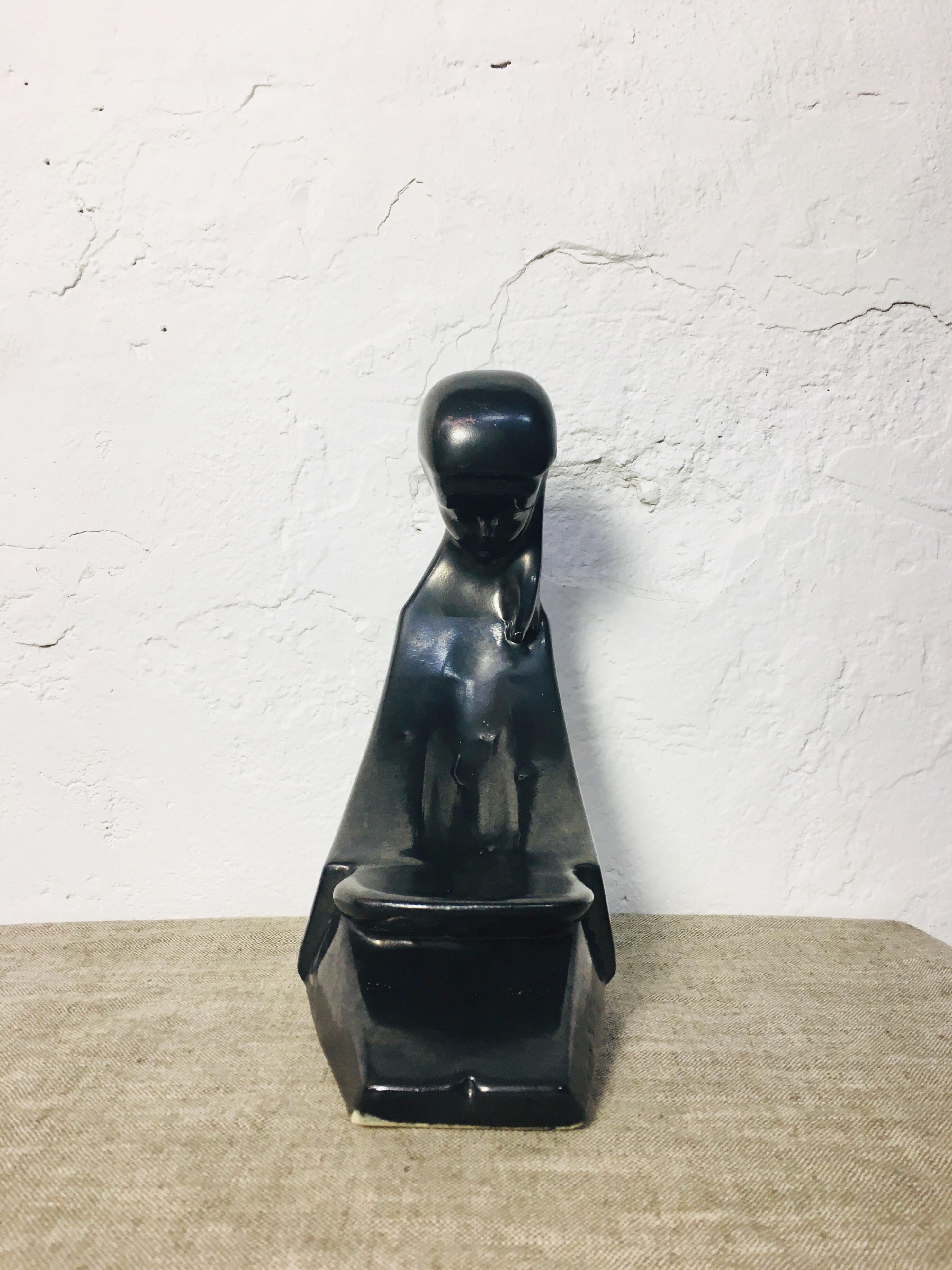 Black glazed Art Deco ceramic book stand figure. Unmarked, perfect condition.
 