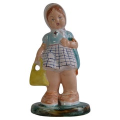 Art Deco Ceramic figurine of a girl with a handbag, circa 1940