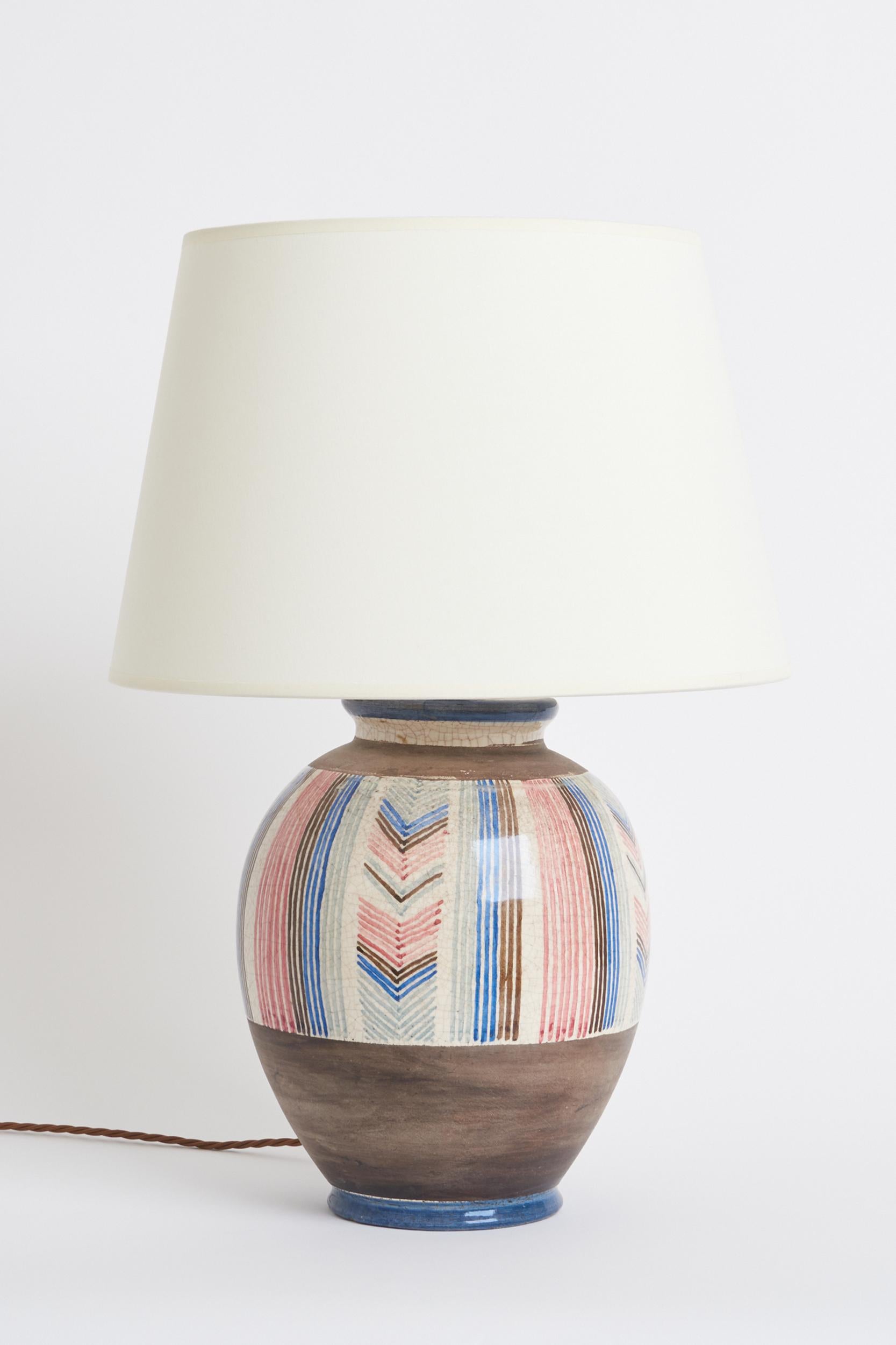 A large Art Deco polychrome ceramic table lamp by Jean-Jacques Lachenal (1881-1941). 
Hand painted, one of a kind. Signed. 
France, 1920s.
With the shade: 58 cm high by 41 cm diameter
Lamp base only: 37 cm high by 24 cm diameter