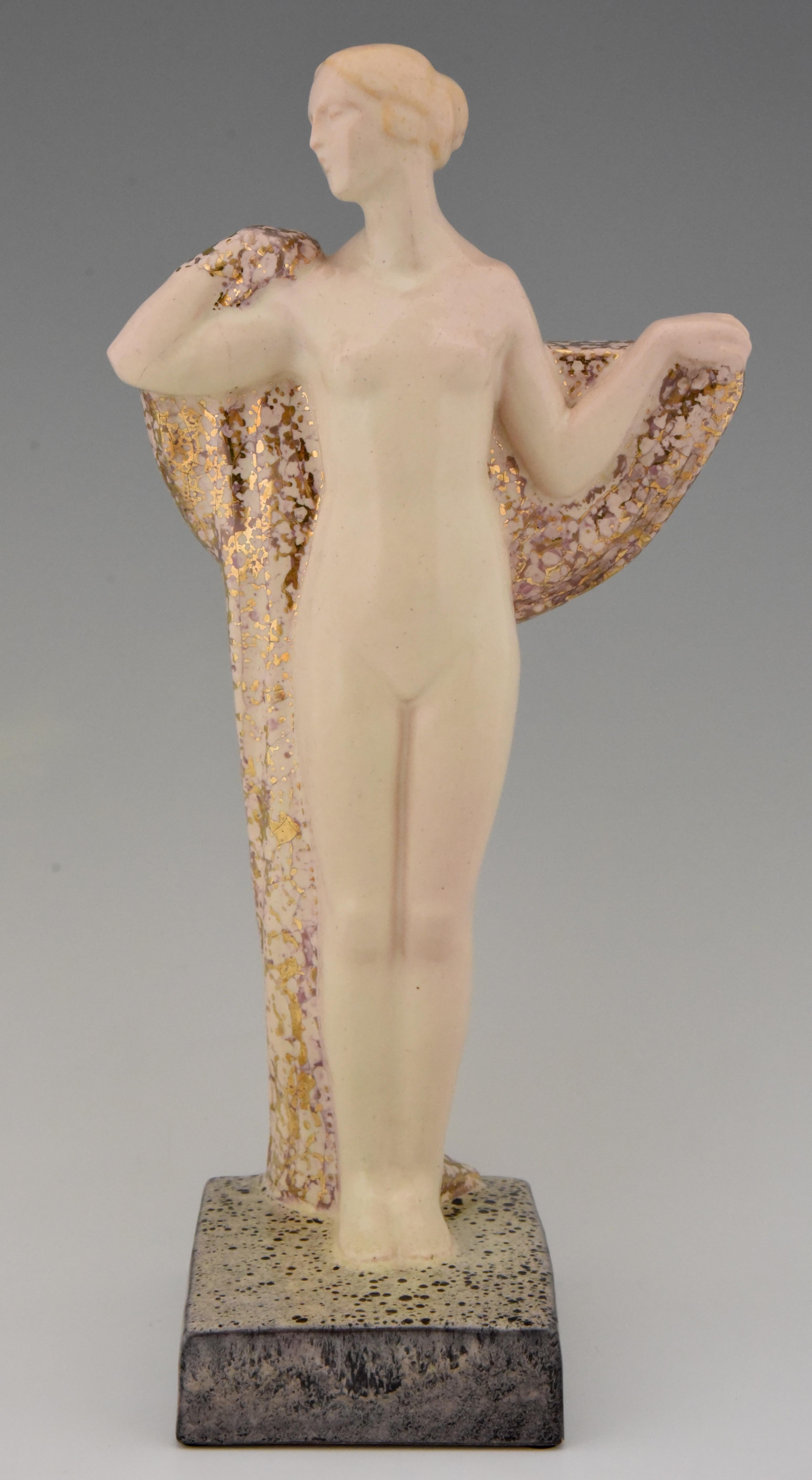 Art Deco ceramic sculpture of a standing nude with drape by Pierre Lenoir. Marked Made in France and with the Boulogne sur Mer stamp. The sculpture has a beautiful colored glaze with gold pattern, circa 1925.
Literature:
“Art Deco sculpture” by