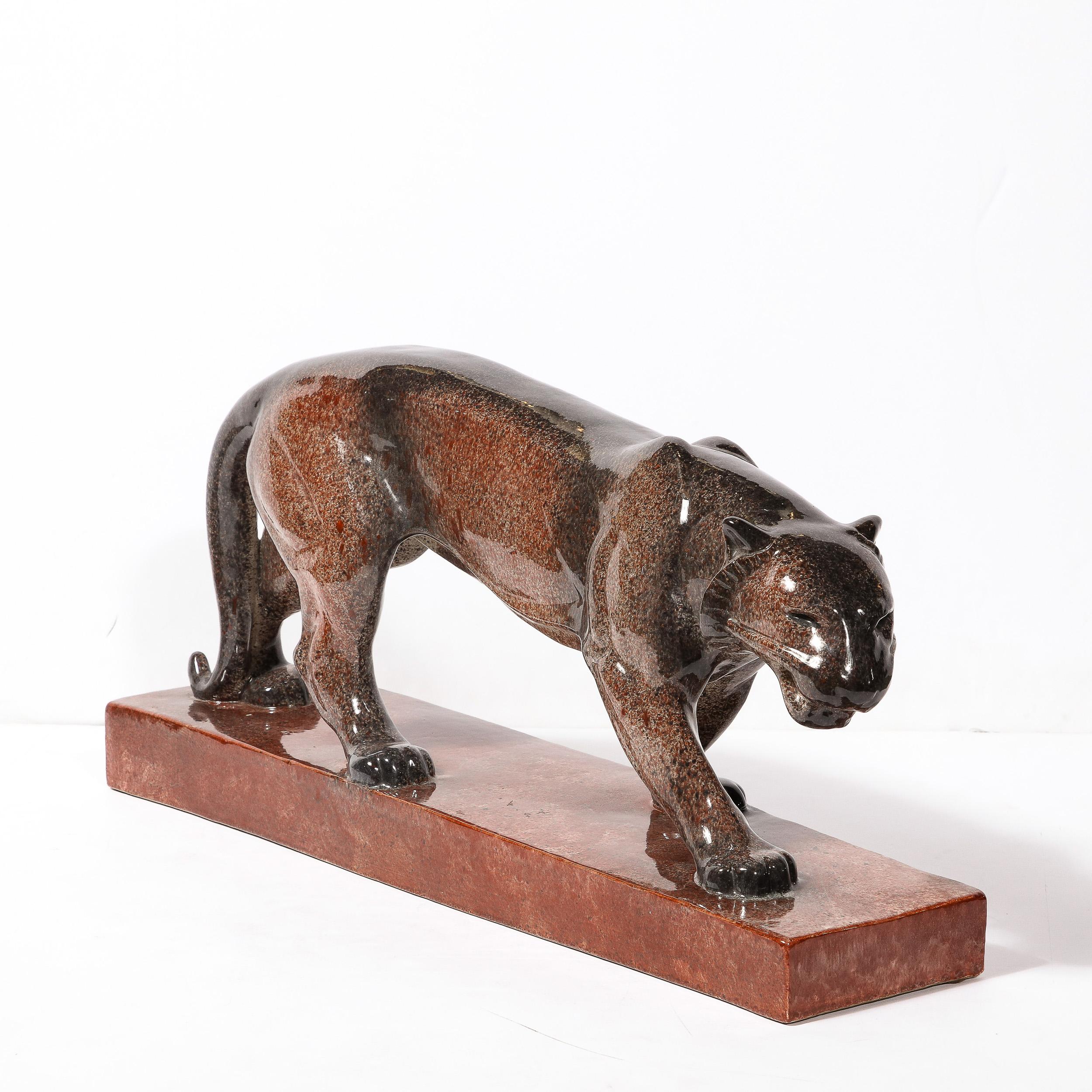 This gleaming Art Deco Ceramic Panther sculpture signed Vago Weiss Originates from France, Circa 1925. Rendered in an optical mixture of stippled charcoal and cool crimson ceramic glazes, the colors relate and blend with stunning gradients across