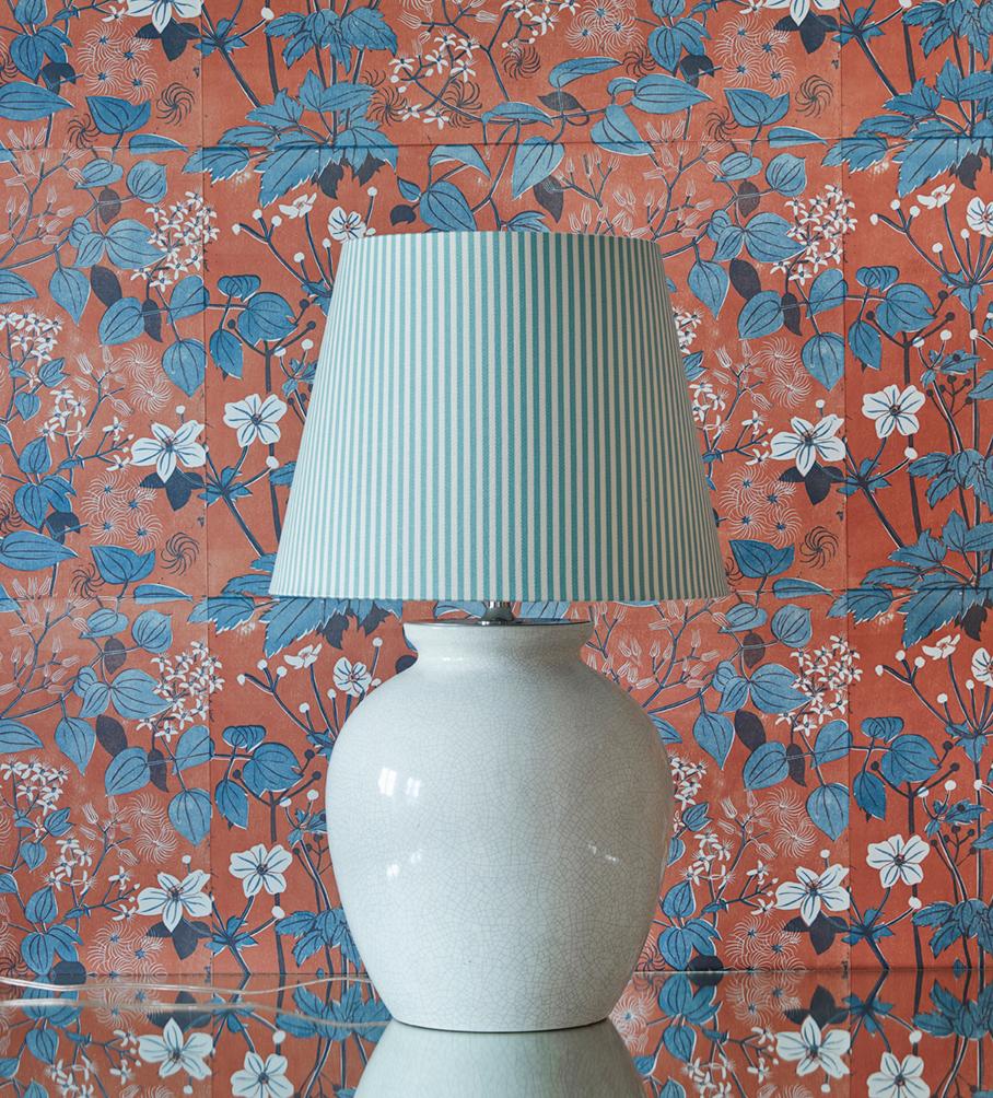 Beautiful Art Deco ceramic table lamp in crème color. New upholstered lampshade in striped textile.