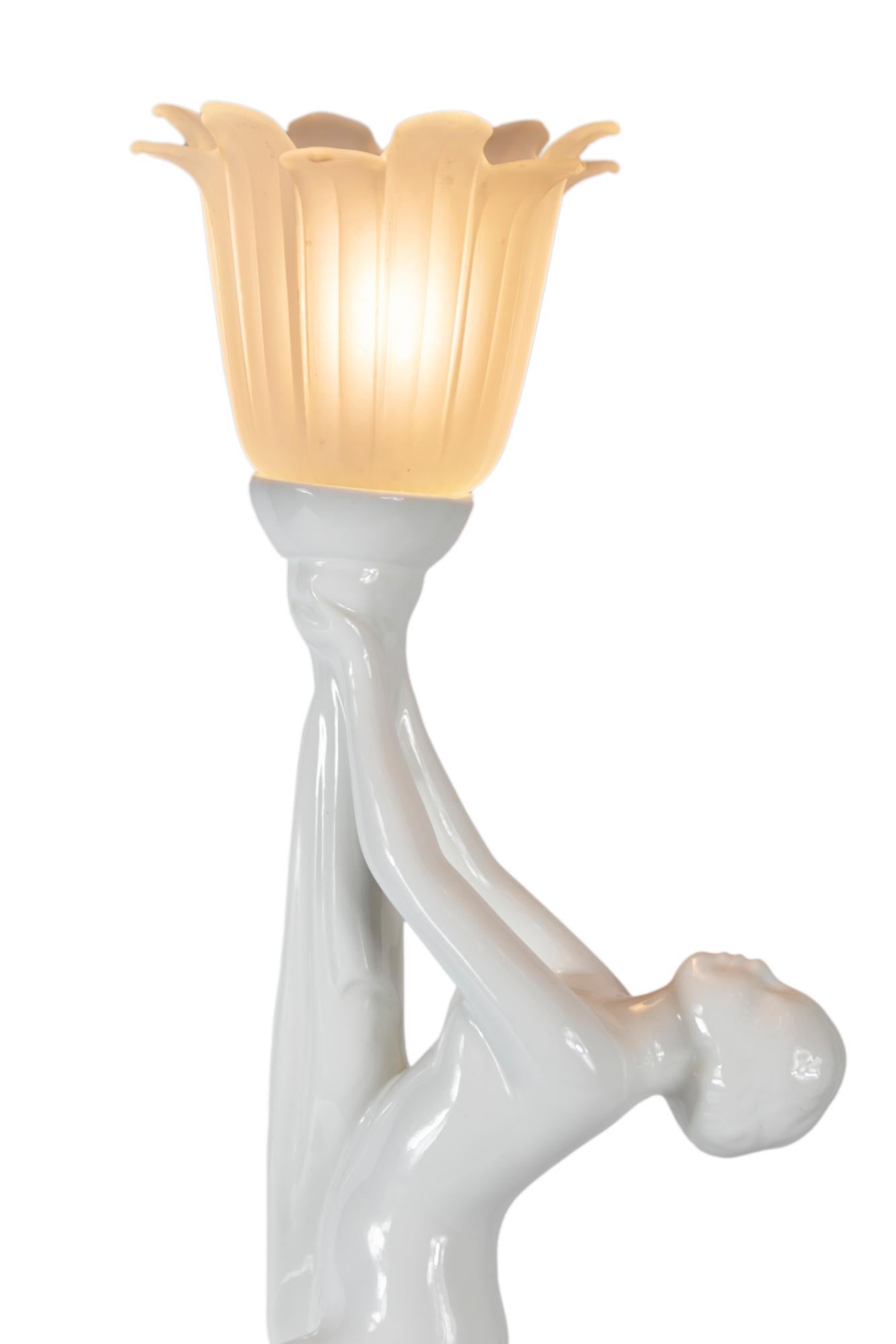 Art Deco glazed surface ceramic table lamp in the form of a woman figure and matt glass shade.
Includes E14 bulb.
  