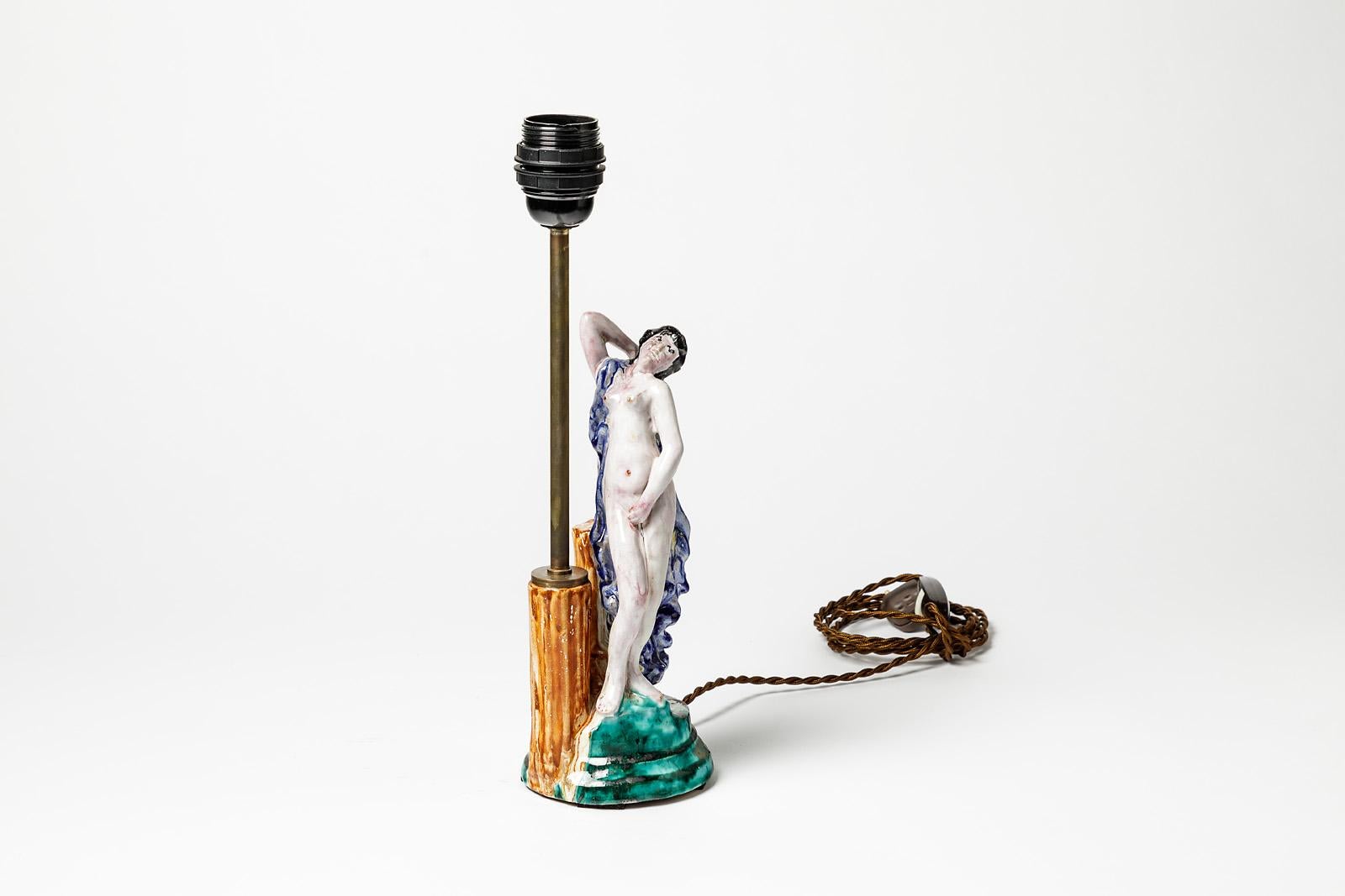 Attributed to René Buthaud (France)

Art Deco period, French production.

Romantic ceramic table lamp with a nude woman and vegetation.

Elegant ceramic piece with shiny colors,

circa 1940.

Electrical system is new.

Ceramic