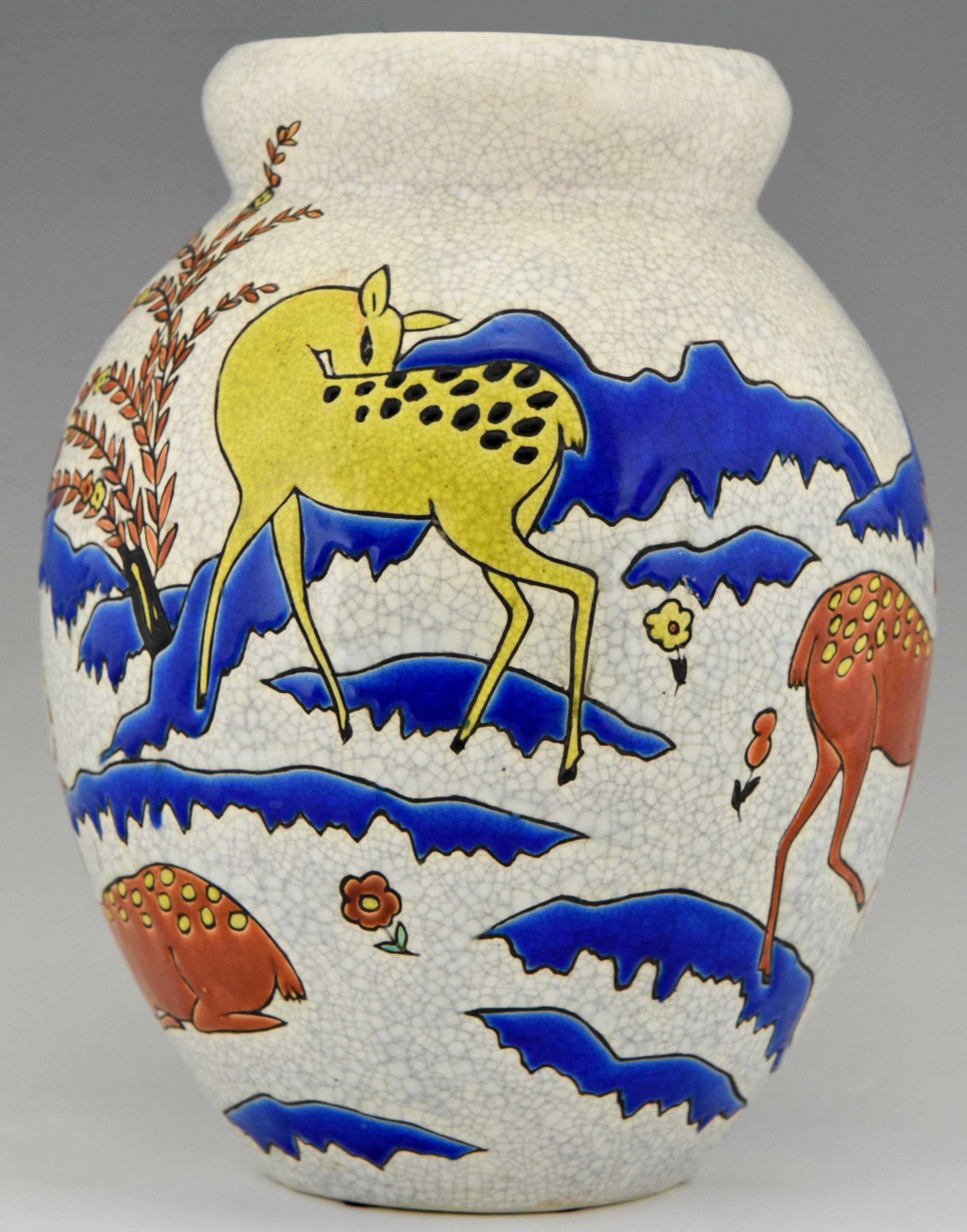 Very rare and impressive vase with dee or doe in a landscape.
Signed by Thérèse Hummel for Boch Freres. Number 843
This model was designed for Atelier La Maîtrise under the direction of Maurice Dufrène in 1923.
The vase has a craquelé glaze in