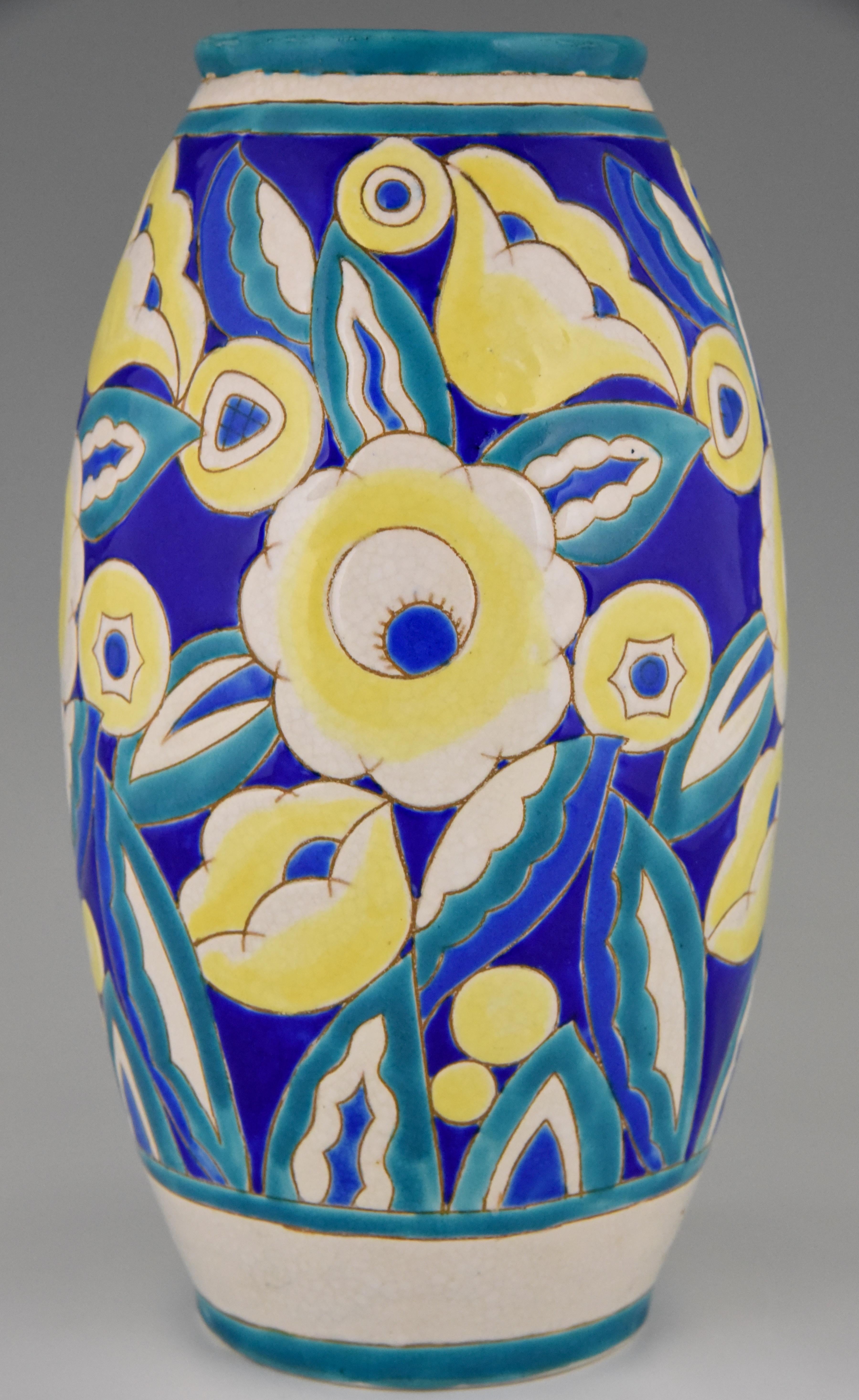 Lovely Art Deco craquelé ceramic vase with flowers by Keramis, signed and numbered, Belgium 1932. Beautiful colors turquoise, blue, white and yellow. 
This decor is illustrated in the book: “Art Deco ceramics Charles Catteau” by Marc Pairon.