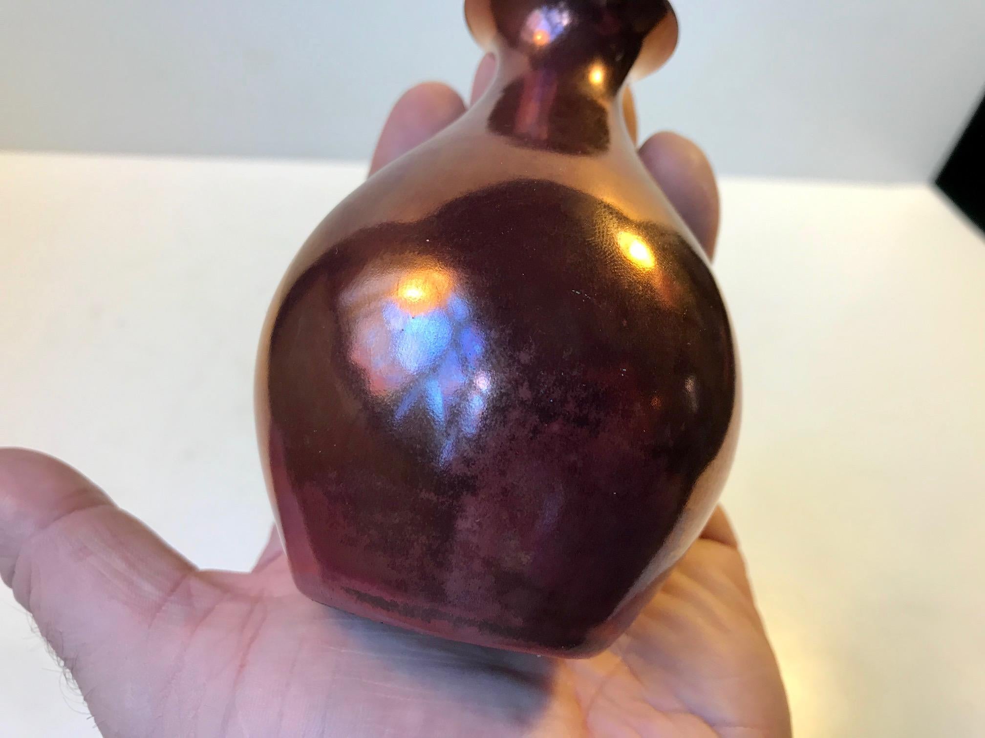 Small unique ceramic vase in copper/metallic lustre glaze. The vase is signed E. B. S. - Klint. Precise attribution is uncertain. But some suggest P.V. Jensen-Klint, Kaare Klint's son Esben Bredsdorf Klint or Swedish Inge Klint.