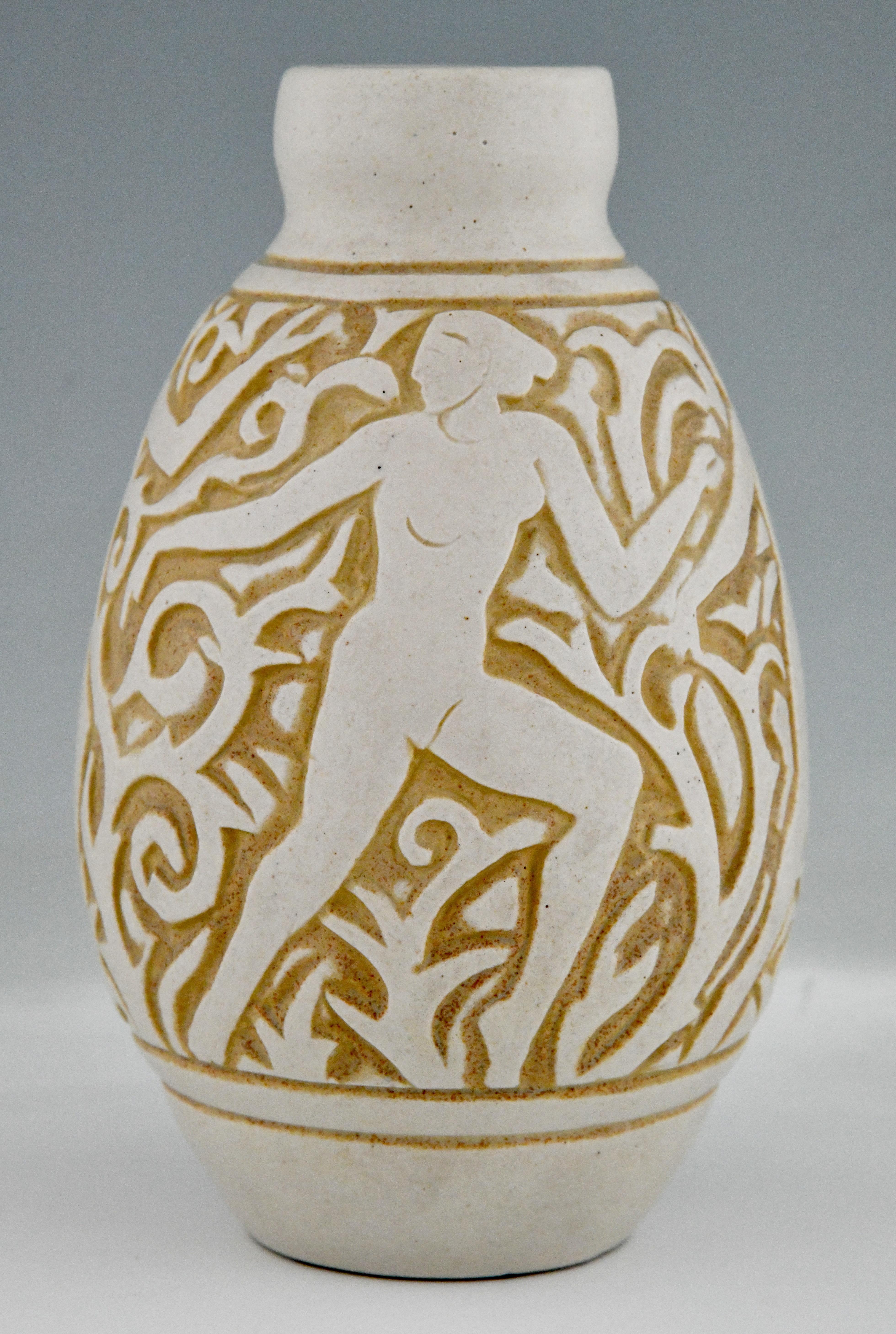 Art Deco ceramic vase with nudes by Mougin Frères design by Gaston Ventrillon or Ventrillon le Jeune. Grès Ceramic with incised decor of dancing nudes and art deco stylized foliage in the colors ivory and ochre yellow. France 1930.
