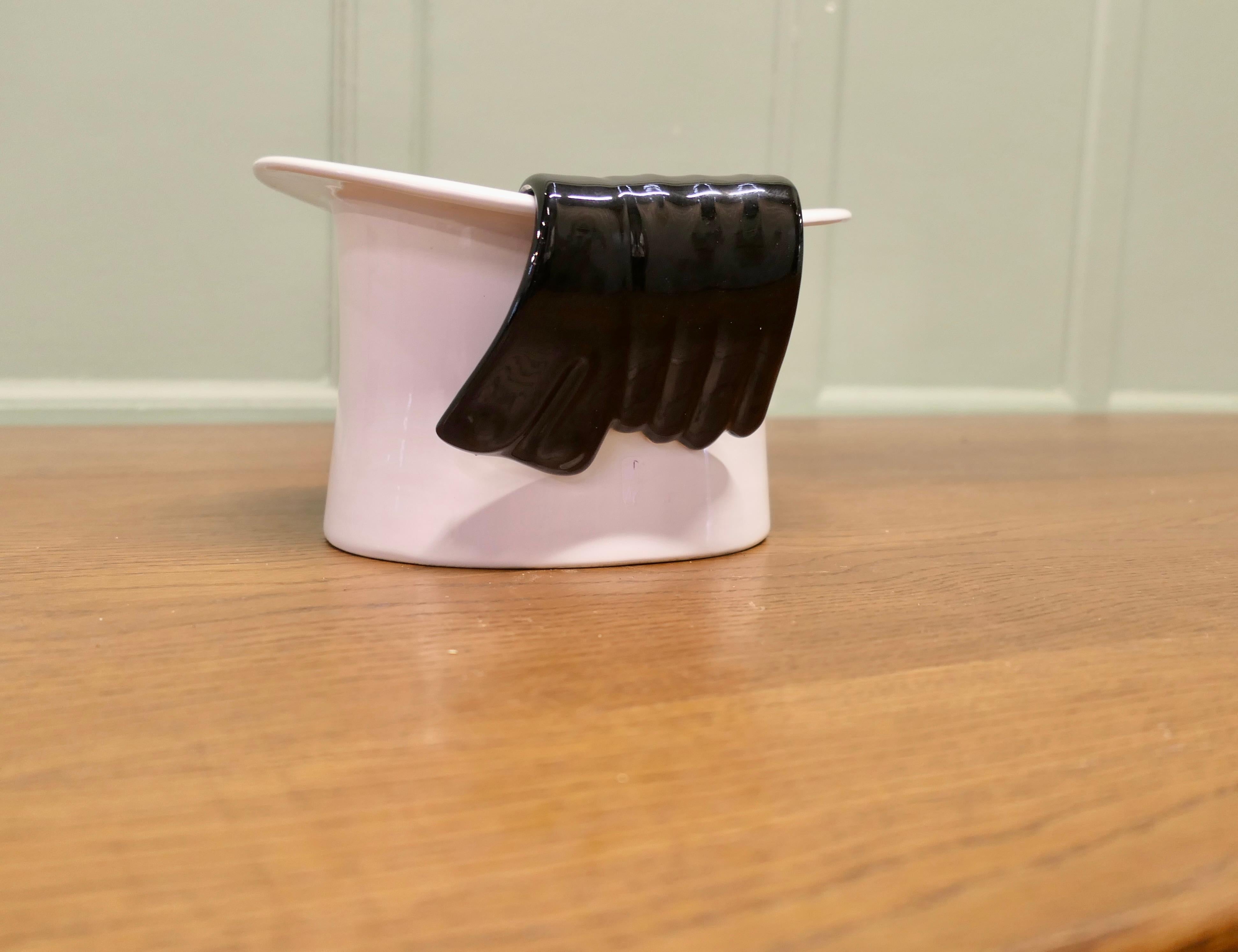 Art Deco Ceramic Wine Cooler, Champaign Bucket

A Very Stylish piece in the form of a white top hat with black gloves hanging on the side
A great piece for anyone who enjoys a drink and fun, in good vintage condition, the hat is 7” high, 10” long