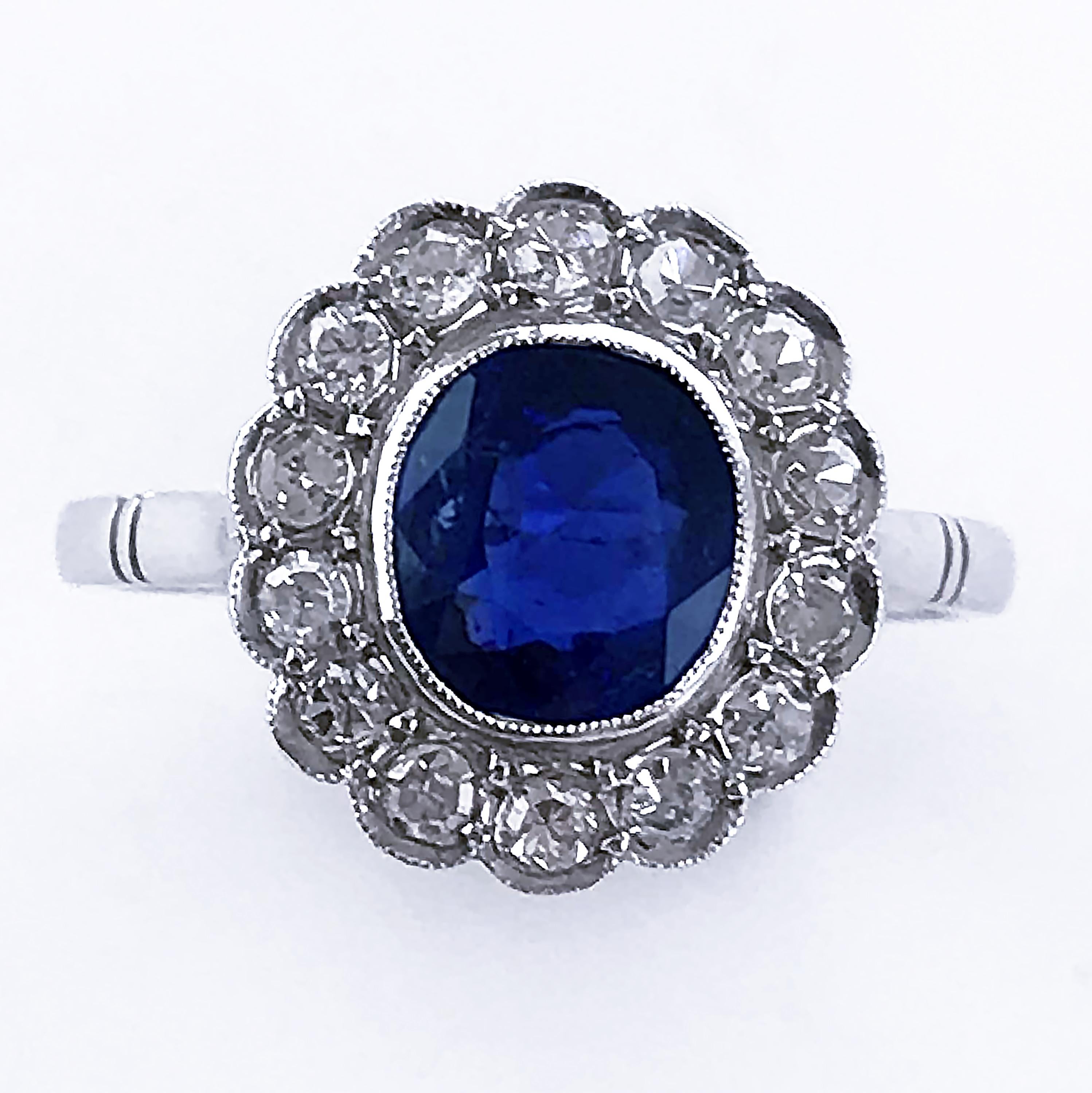 Platinum Art Deco Natural Untreated Certificated Burma Blue Sapphire and Diamond, vintage ring, handmade in England, circa 1920.

Central Burma Blue Sapphire 1.44 carats (total), natural untreated, no heat, colour, oval with antique faceted mixed