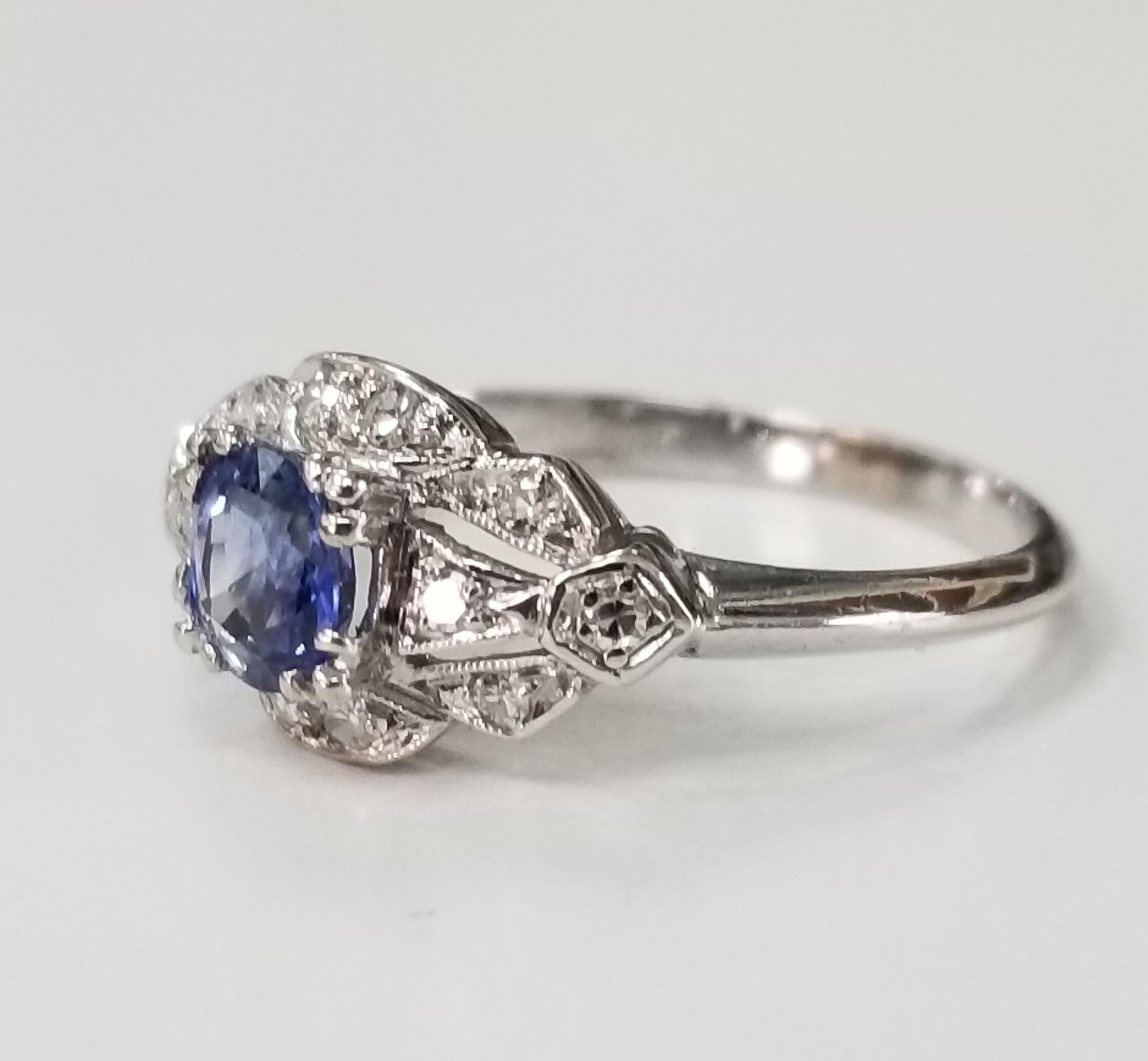 Platinum  sapphire and diamond ring containing 1 oval ceylon sapphire weighing .60pts. and 12 round single cut diamonds weighing .24pts.  This ring is a size 5.5 but we will size to fit for free.