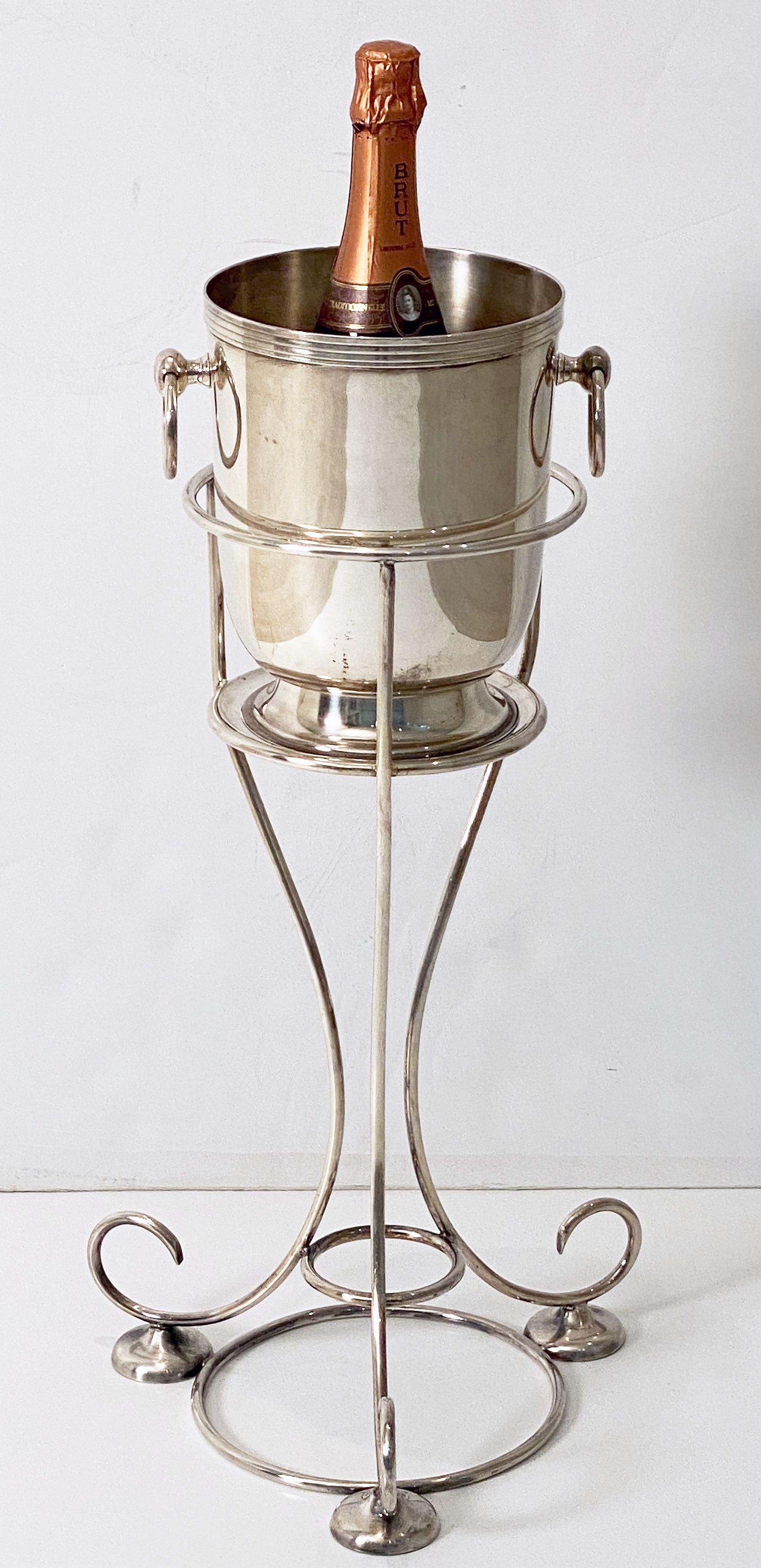 A period English champagne bucket or wine cooler with ring handles on a stylish frame stand of fine plate silver, from the Art Deco era by the celebrated silversmiths, Yeoman of England - the silver giftware supplier to Harrods and other prestigious