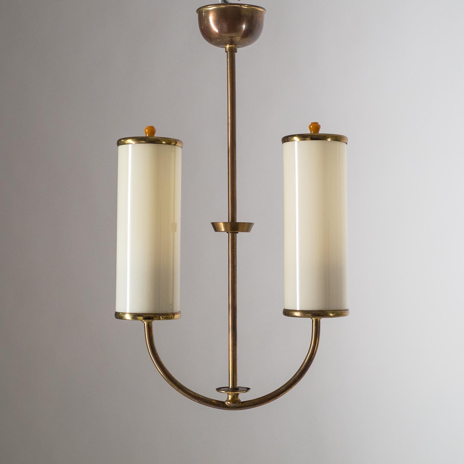 Charming small two anchor-shaped 1930s Art Deco chandelier. Two ivory-colored glass tubes with brass hardware and bakelite finials. Fine original condition with a nice patina on the brass. Two original bakelite E27 sockets with new wiring.