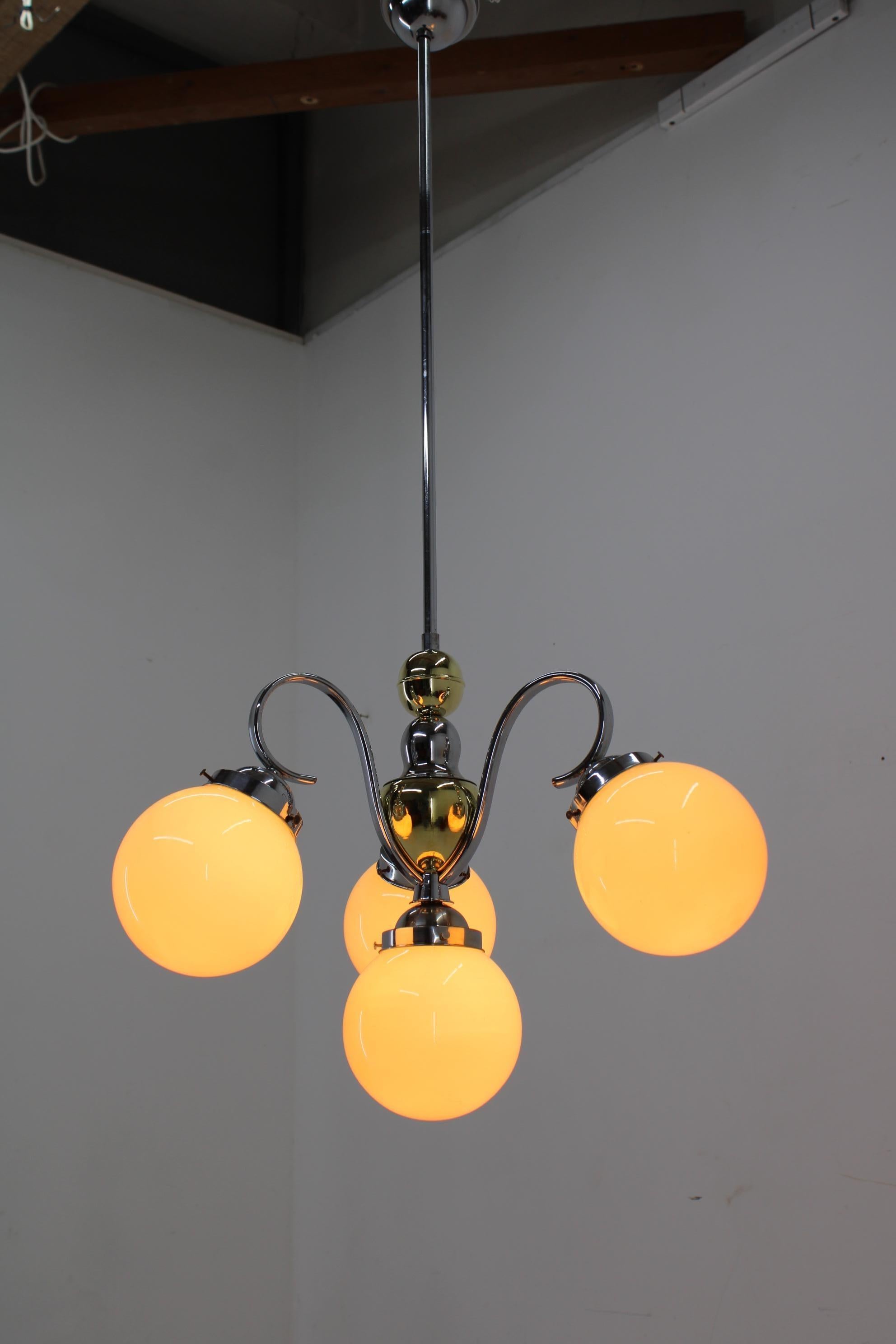 Beautiful Art Deco chandelier made in 1930s in Czechoslovakia. 
Champagne color glass shades.
Restored: cleaned, polished, rewired - two separate circuits: 1+3x40W, E25-E27 bulbs
US wiring compatible