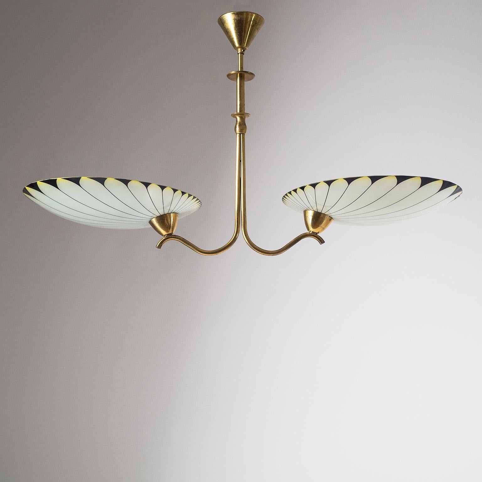 Graphical two-arm Art Deco chandelier from the 1940s. Brass structure with two large curved and enameled glass shades with a graphical palm leaf decor in black, yellow and ivory color. Very nice original condition with patina on the brass. Two brass