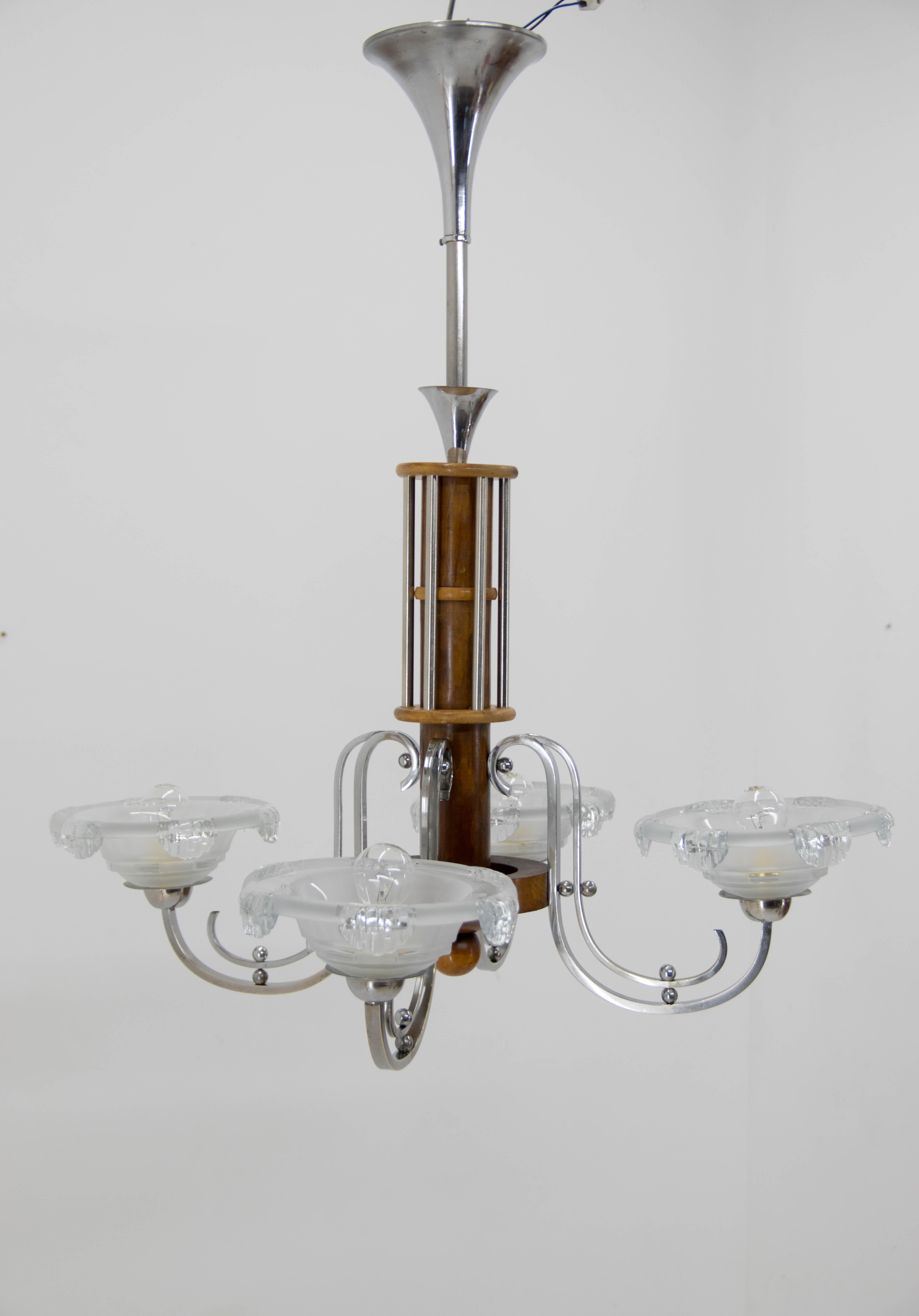 French Art Deco chandelier with the original set of four opaque icicle design molded glass shades. Wooden central column with chrome attributes.
Item was carefully cleaned, polished and rewired: 4x60W, new E12-E14 sockets.
US wiring compatible.