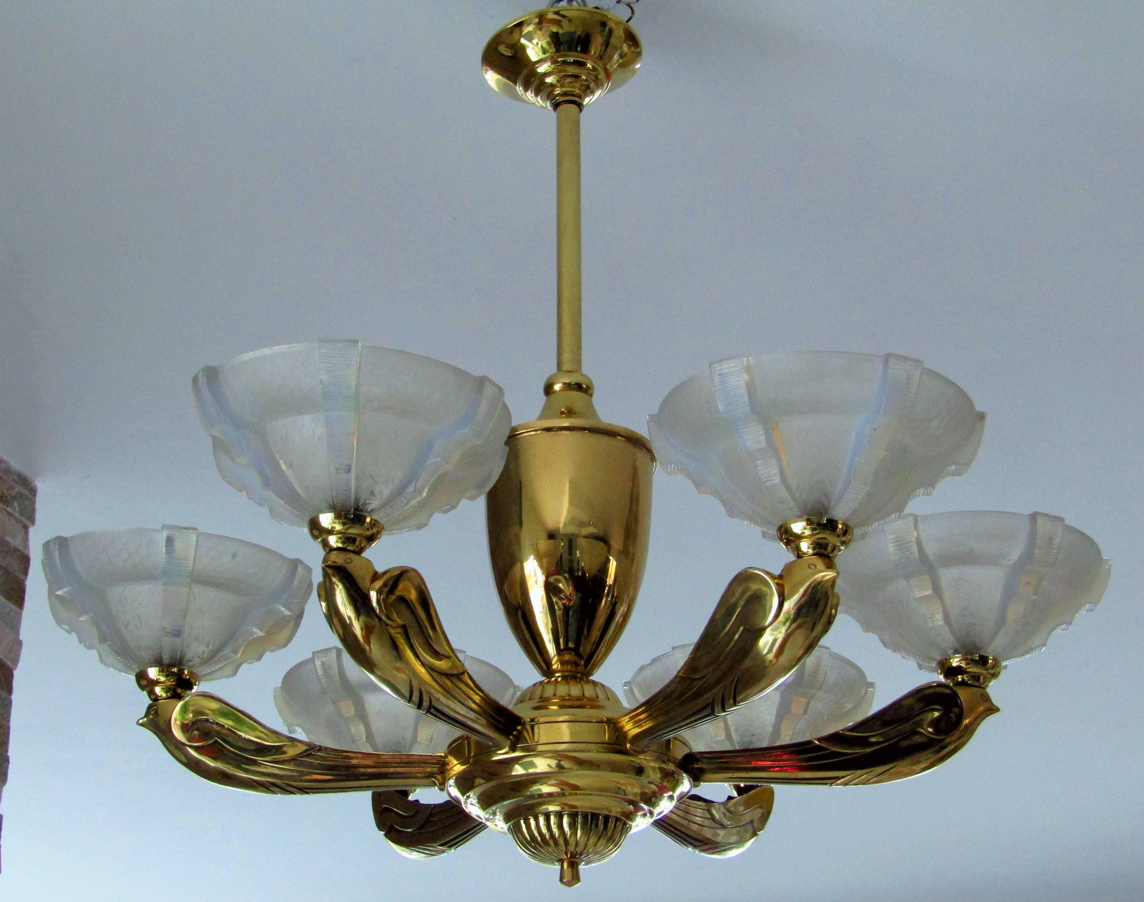 Art Deco chandelier by Boris Lacroix, France, 1935. 24-karat gold-plated. Opalescent glass shades. Four small dents at the middle part. One micro chip at one shade. See pictures! Rewired. Birds gold-plated bronze!

