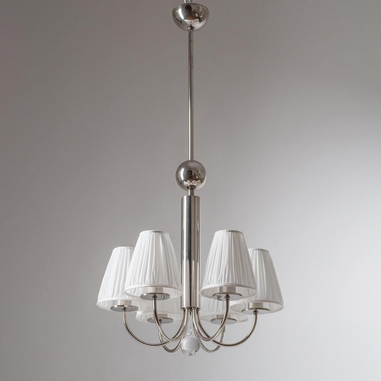 Rare six-arm Bauhaus chandelier, circa 1930. Nickeled brass hardware and a large glass 