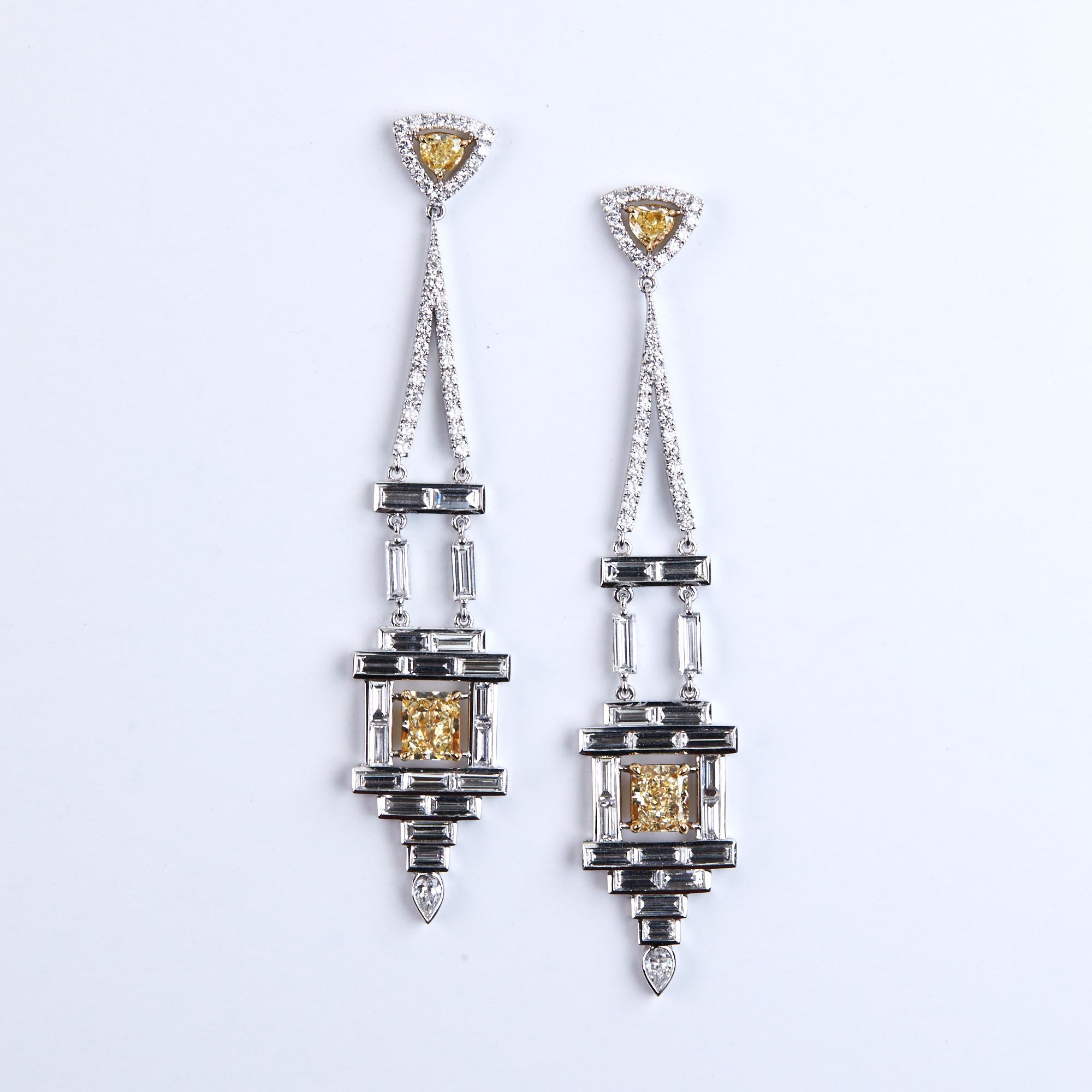 Art Deco Inspired Chandelier Diamond Earrings are a one of kind showpiece.  These Dangle Earrings boast 2 Fancy Yellow Radiant Cut GIA Certified Diamonds weighing 2.25 carats, 2 Fancy Yellow diamonds at the top weighing .59 carats.  40 Baguette Cut