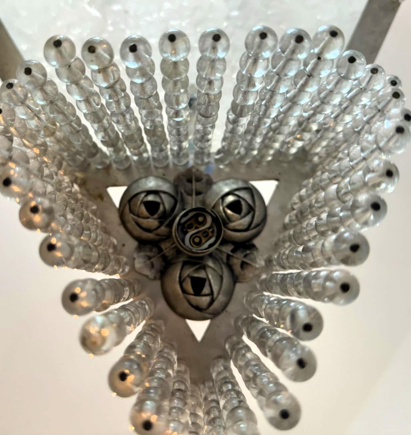 Beautiful and small 4 light chandelier, manufactured in France circa 1920 in nickel plated brass, pressed glass and crystal beads, showing stylized roses throughout its design.
The style of the crystal bead fringe is reminescent of the those
