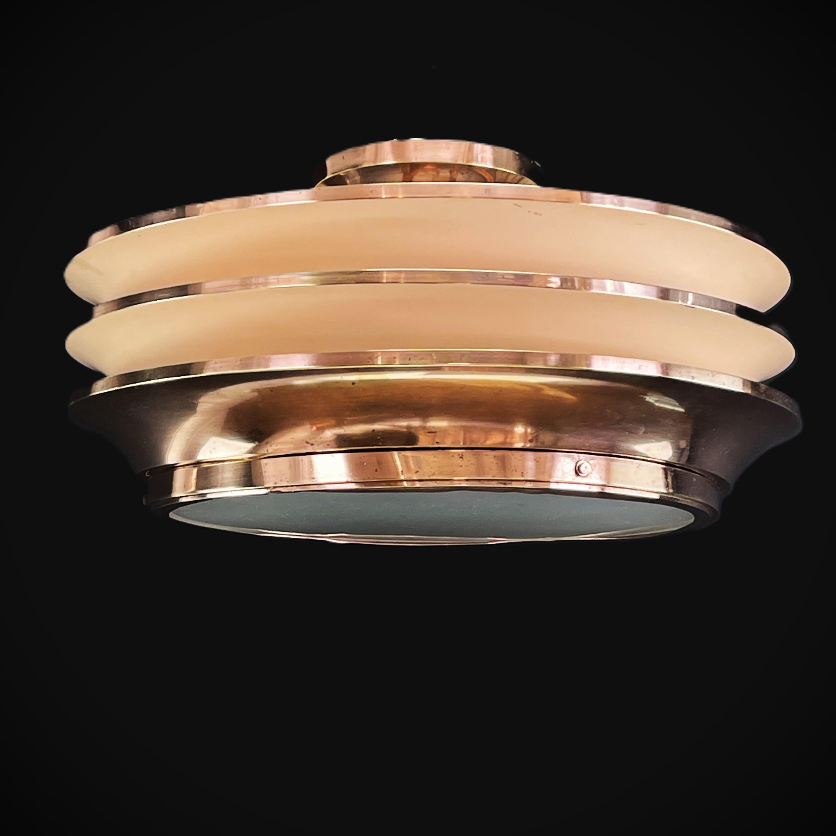 ART DECO hanging lamp design Georges Halais for Eloctra copper, 1930s

The ART DECO ceiling lamp is a remarkable example of the craftsmanship and style of the early 20th century. 

This exclusive masterpiece combines high-quality glass and