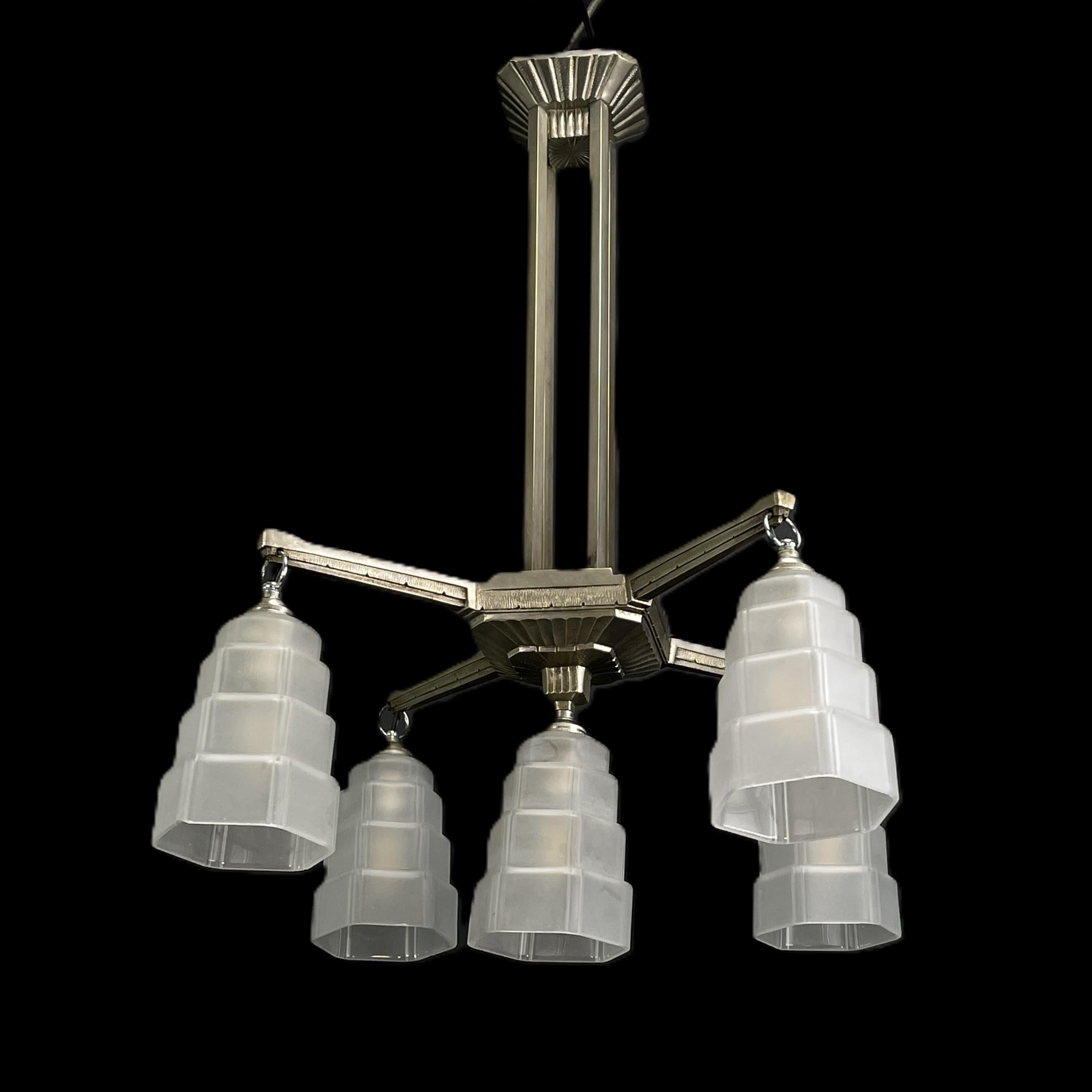 Art Deco Chandelier nickel-plated Skyscraper ceiling lamp, 1920s

The ART DECO ceiling lamp is a remarkable example of the craftsmanship and style of the early 20th century. 
This ceiling lamp skilfully combines metal and glass with elegance,
