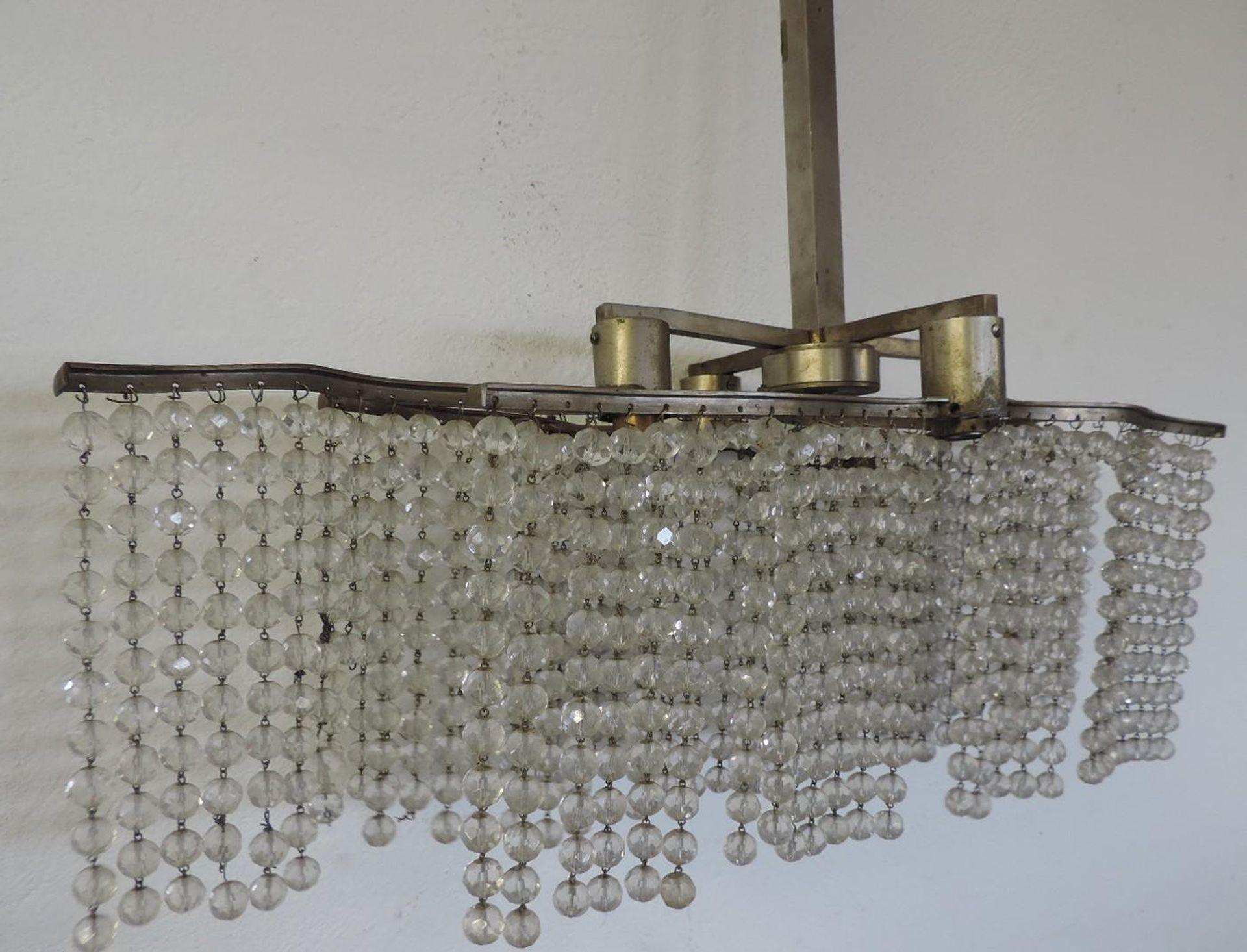 Elegant Art Deco chandelier, made of three fringes of pearls and metal, style Sue et Mare, Ruhlmann.
