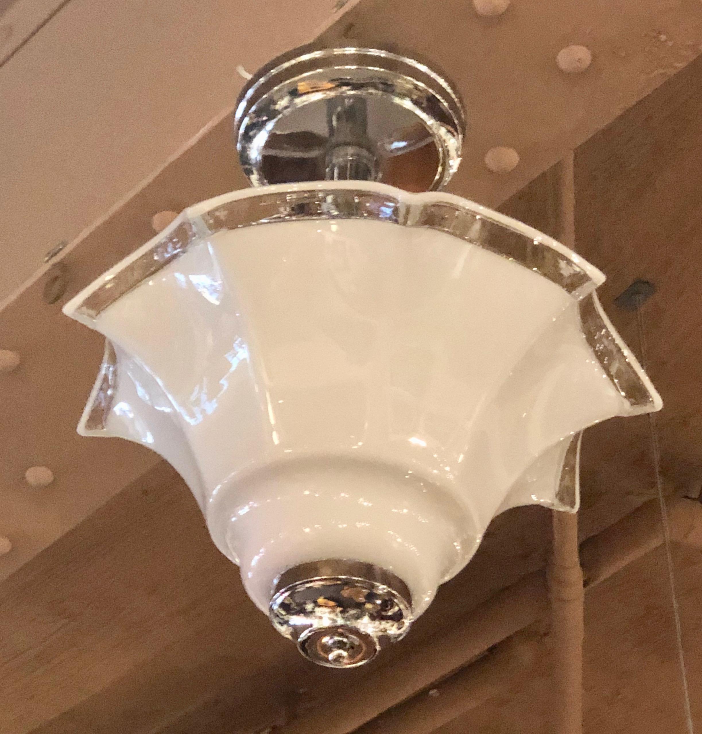 Beautiful flutted Murano style milk colored glass chandelier. Nice original excellent condition chrome hanging assembly. We have two matching fixtures to offer, each has 3 sockets. Open top allows all kinds of wattage using American style standard