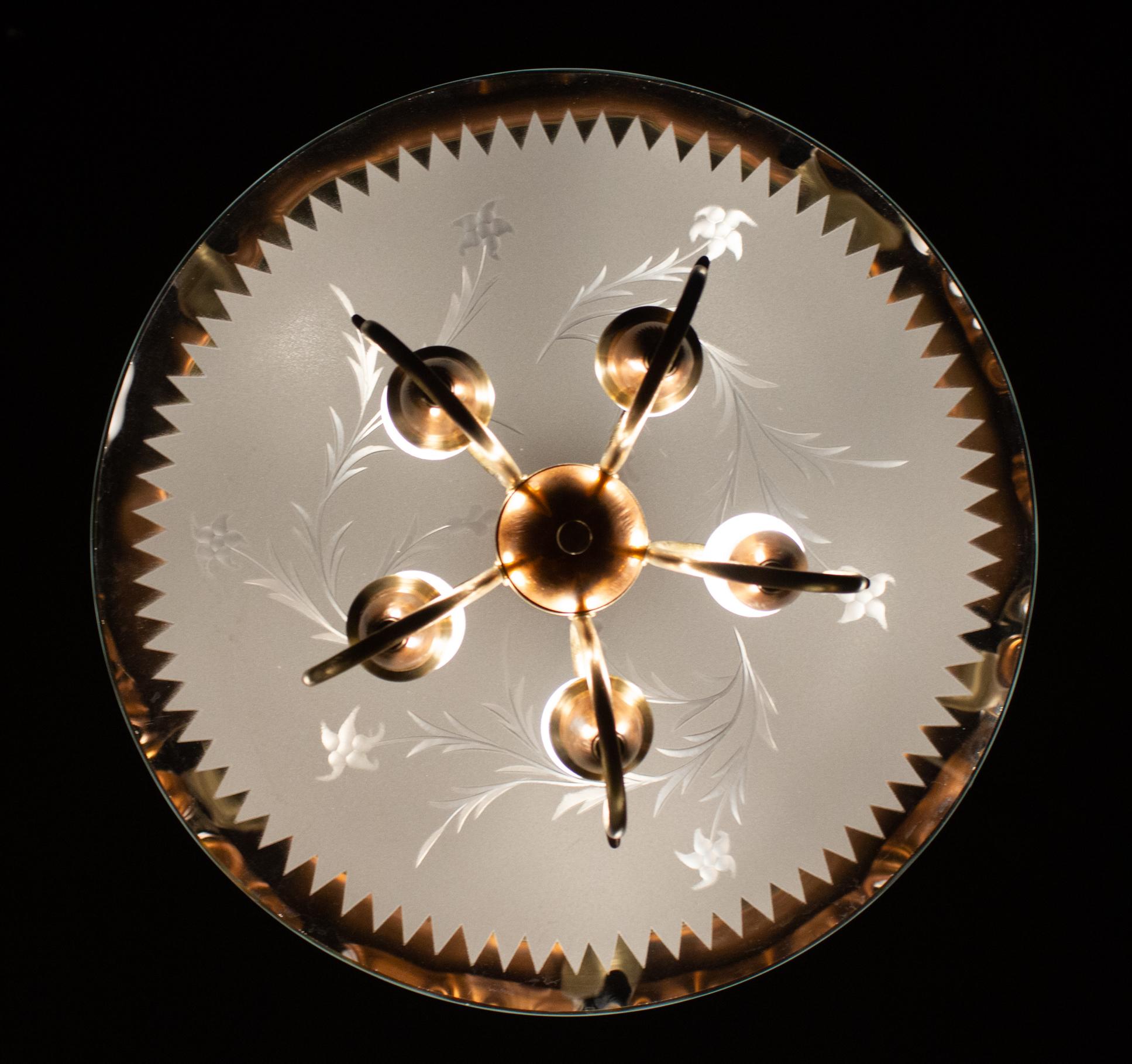 Delicious Art Deco chandelier with scrolled brass terminating in five scallop edged flower form socket cups, supported by finely etched glass. Attributed to Pietro Chiesa style for Fontana Arte.
Excellent original vintage condition.
Length of drop