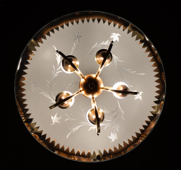 Delicious Art Deco chandelier with scrolled brass terminating in five scallop edged flower form socket cups, supported by finely etched glass. Attributed to Pietro Chiesa style for Fontana Arte.
Excellent original vintage condition.
Length of drop