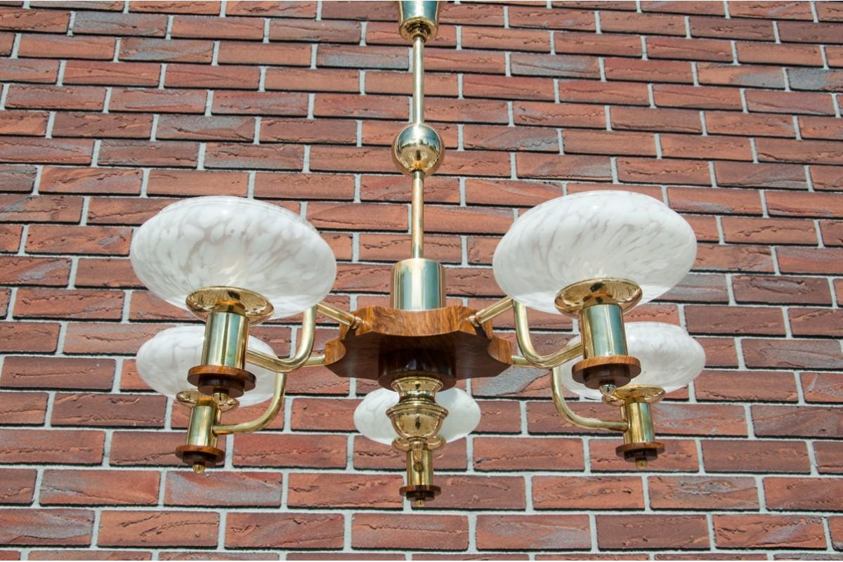Art Deco chandelier made of walnut wood, white glass shades and brass parts, in Poland in the 1950s. Very good condition. The lamp is in working condition

Dimensions: height 68 cm / diameter. 74 cm.

