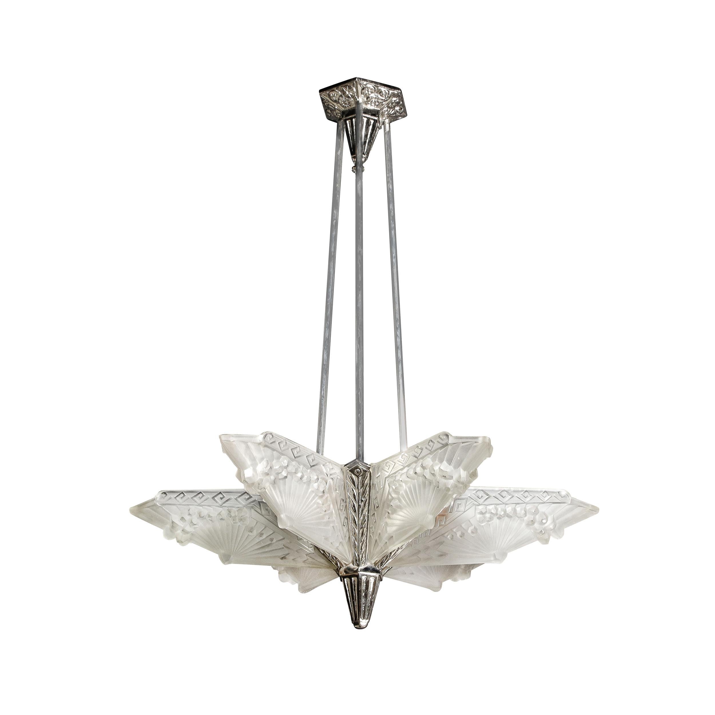 This stunning Art Deco frosted glass and nickel chandelier was realized by the illustrious atelier of Charles Schneider in France circa 1930. The chandelier features a conical channeled finial and a nickeled frame with stylized flame detailing