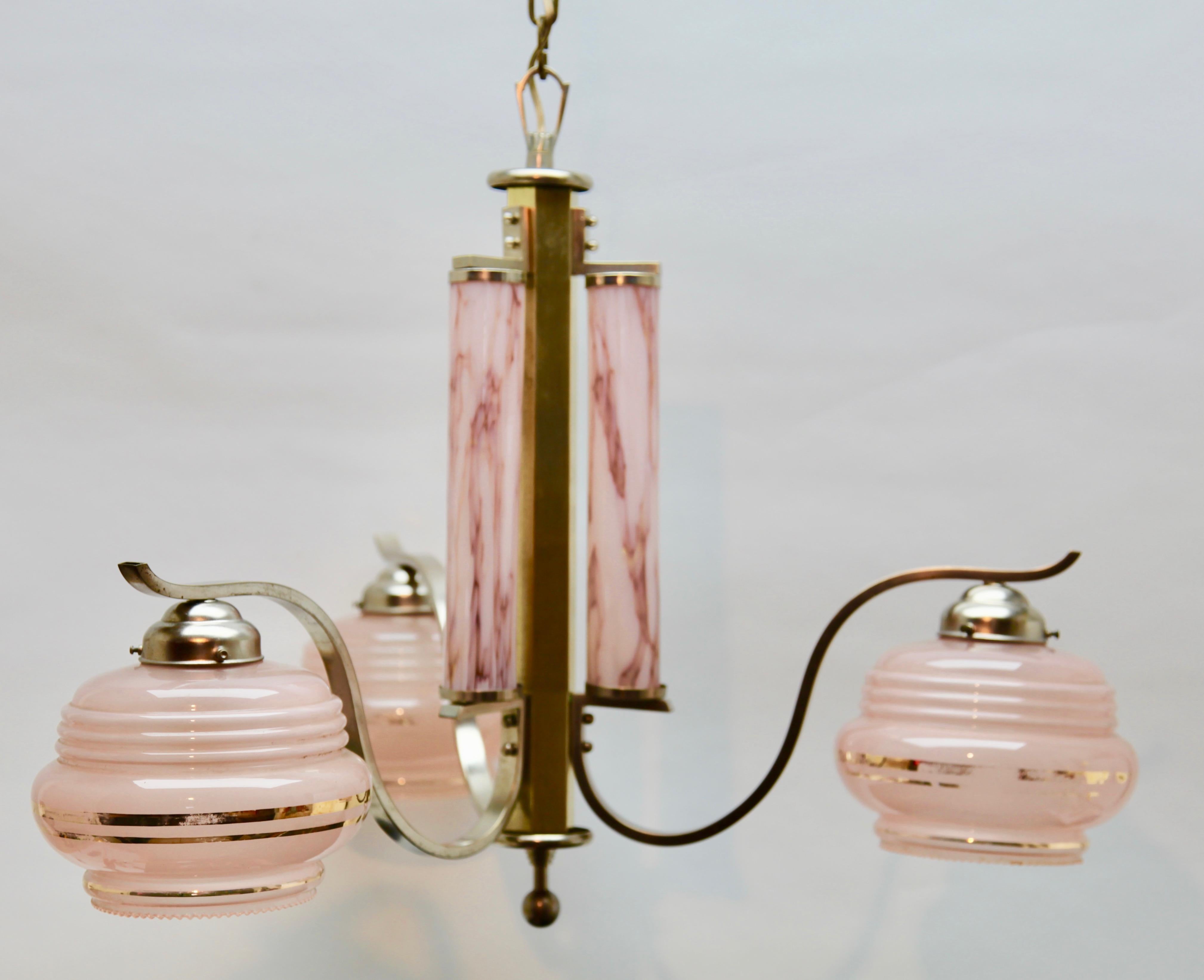 Art Deco chandelier on a fixed rod pendant with three arms and mounts of chromed metal, in the style of Kalmar. Unusual glass lampshades 

As service: We can adjust the lamp height for you in advance if needed.

In good condition and in full