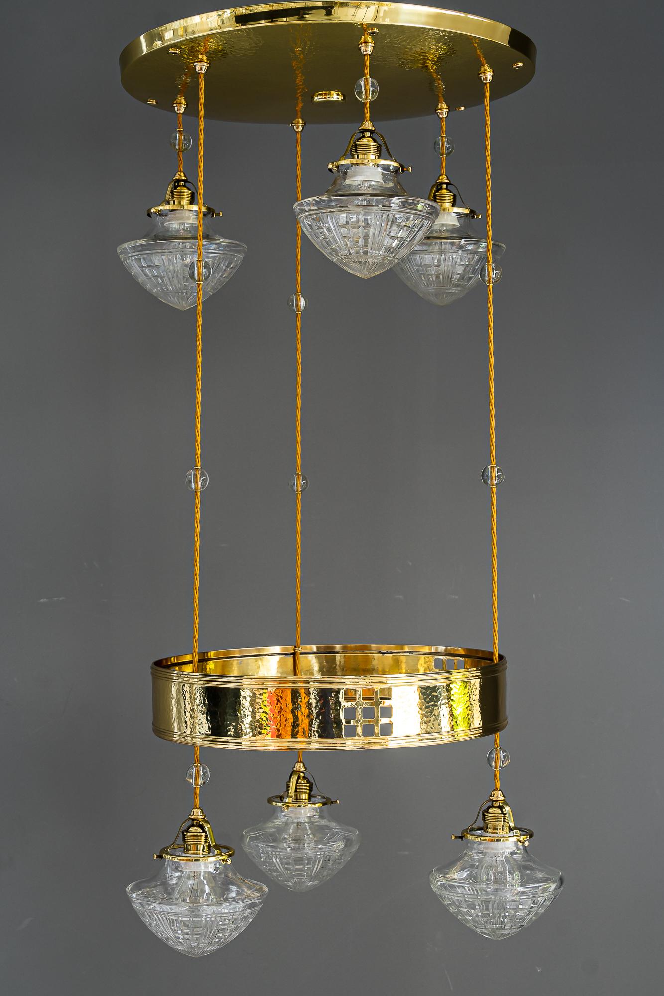 Art Deco chandelier vienna around 1920s
Brass hammered
Polished and stove enamelled
Original antique cut glass shades
We can adjust the height of the chandelier to your room height
The wires are replaced ( new )
The glass balls on the wire are