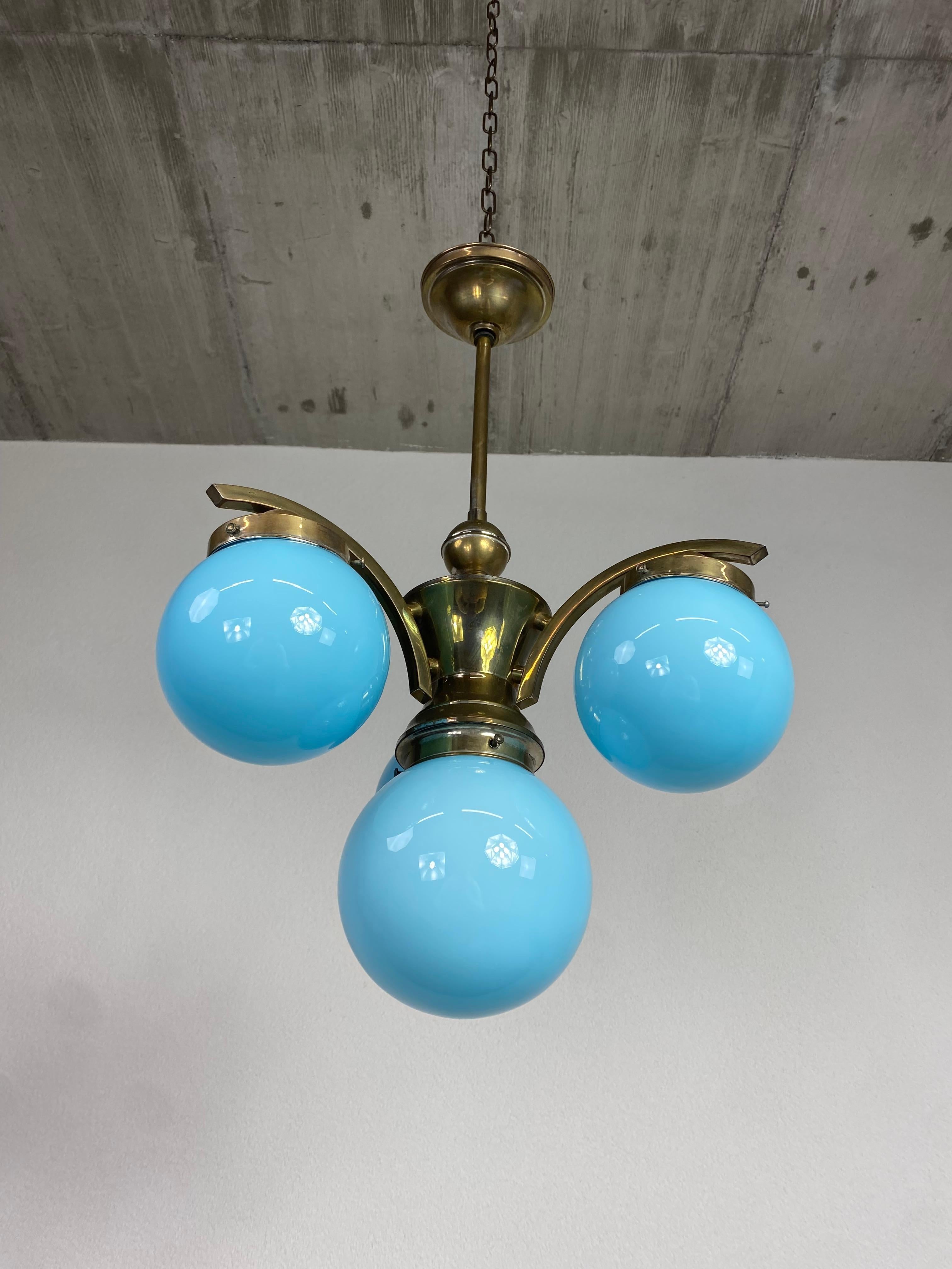 Art deco chandelier with blue lampshades in original vintage condition.
