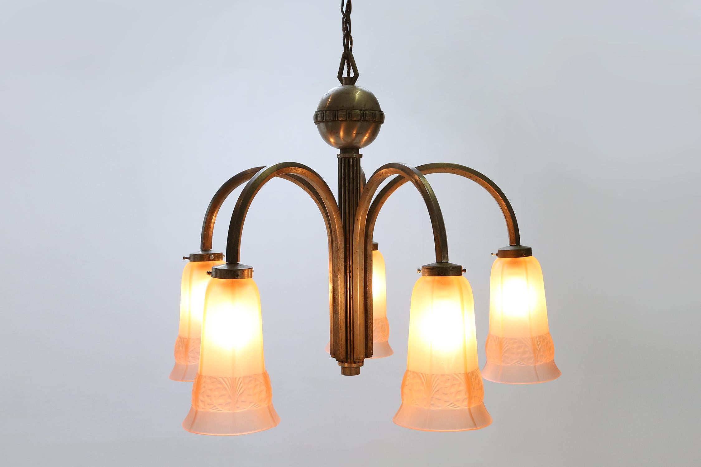 Belgium / 1930 / chandelier / copper, glass, nickel / Art Deco

Elegant Art Deco chandelier with five pink etched glass lampshades and a nickel plated copper frame. Manufactured in Belgium around 1930. 

Each lampshade has gracefully floral