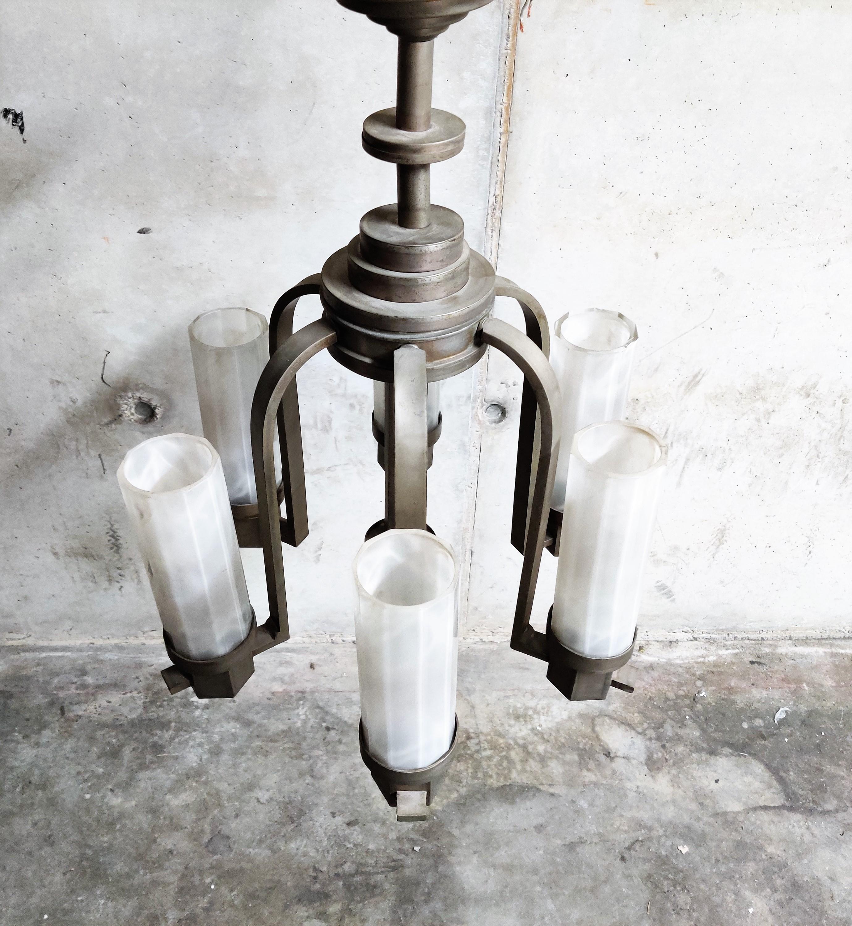 Original Art Deco era chandelier with 6 frosted glass lamp shades.

This beautiful chandelier features a typical Art Deco design with just the right patina.

The chandelier will be professionally rewired.

The glass shades are all original and