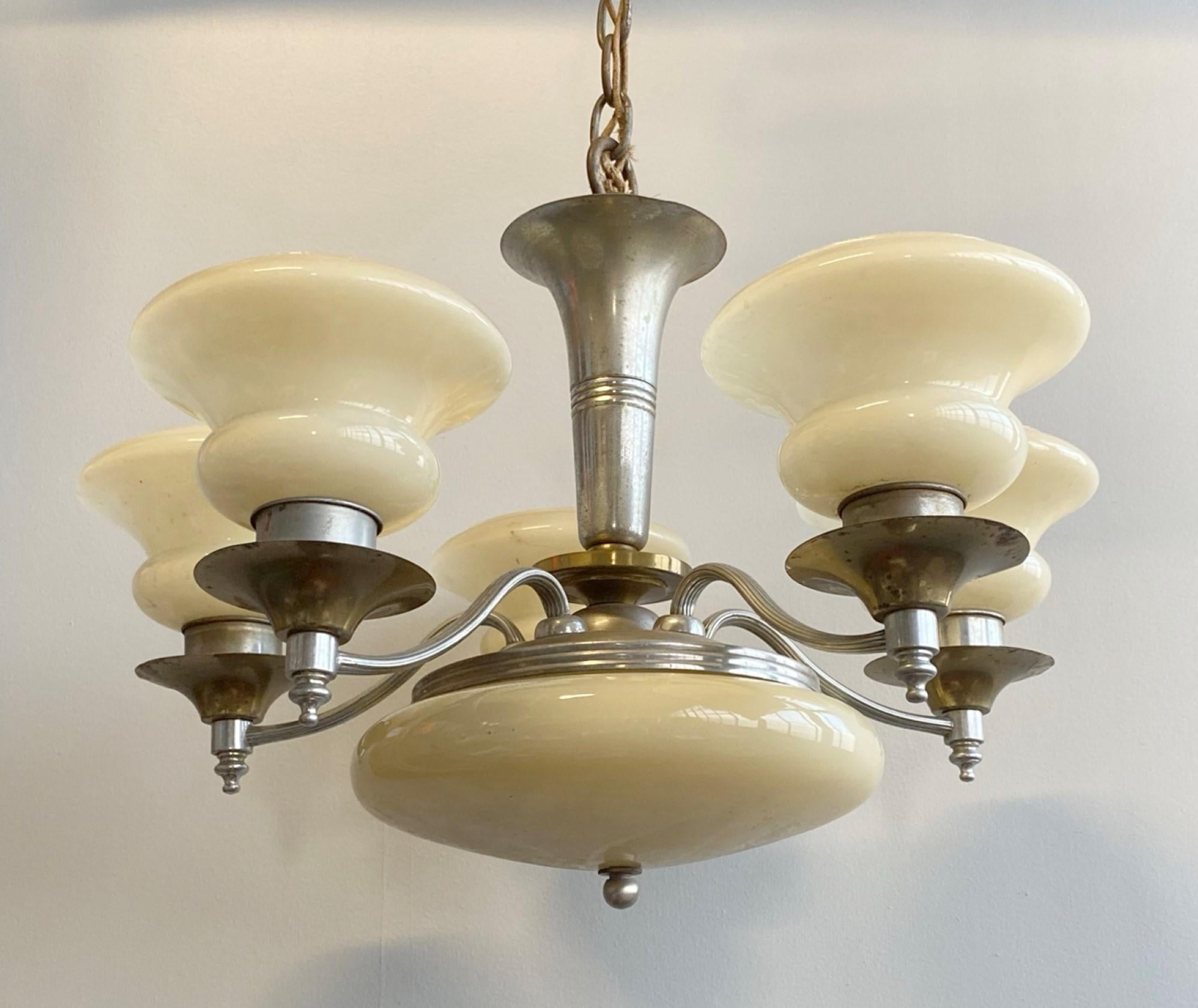 Early 20th century Art Deco nickel plated five arm chandelier with custard glass shades and matching illuminated bottom custard glass globe. Totaling seven lights, two in the bottom globe and one in each arm. Cleaned and rewired. Please note, this