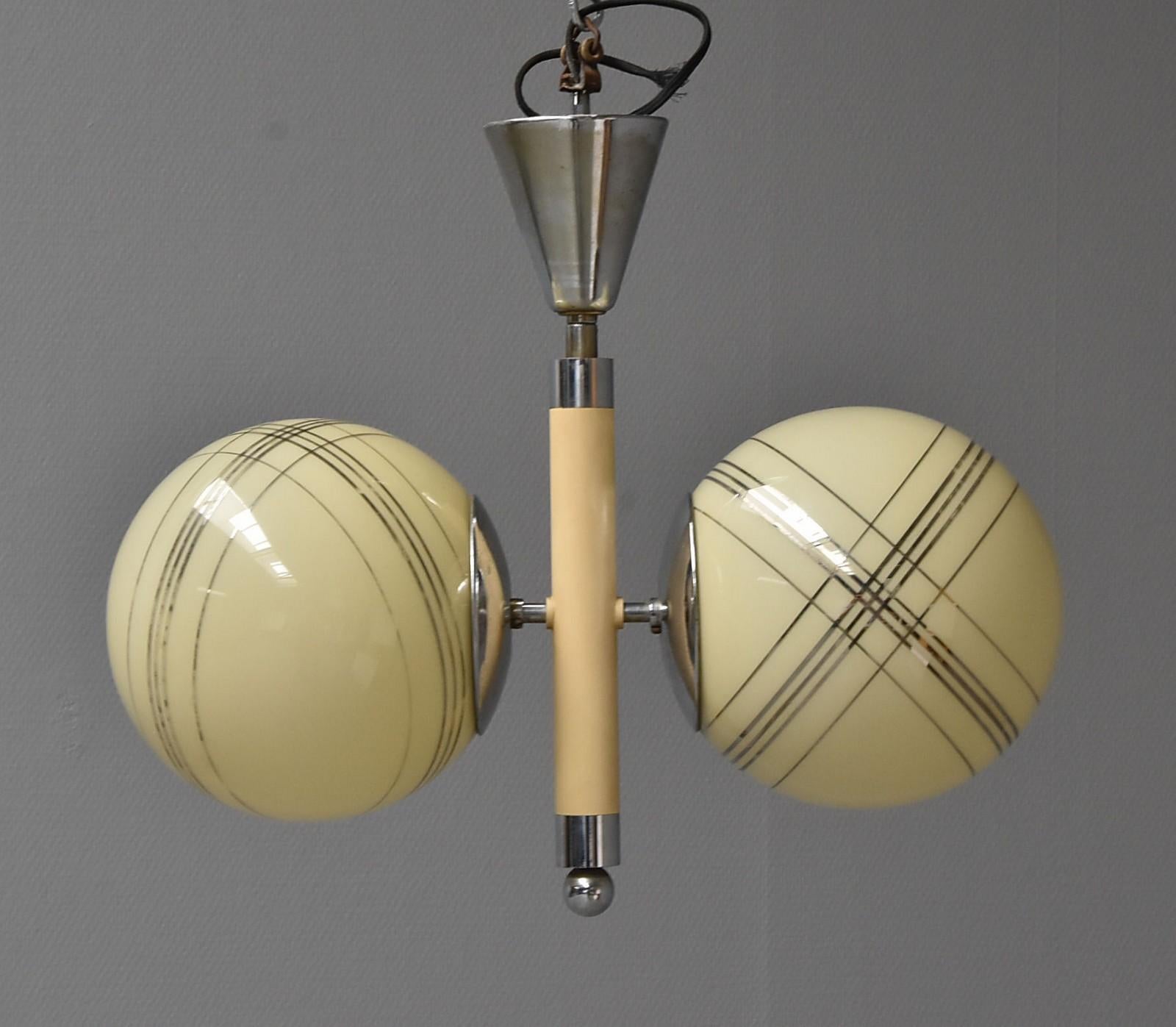 Art Deco chandelier with a nickel-plated brass frame, globe-shaped striped glass shades. Manufactured in Denmark in the 1920s. Measures body: height 42, width 45cm, old usage, and friction marks.
The length will be customized on request.
 