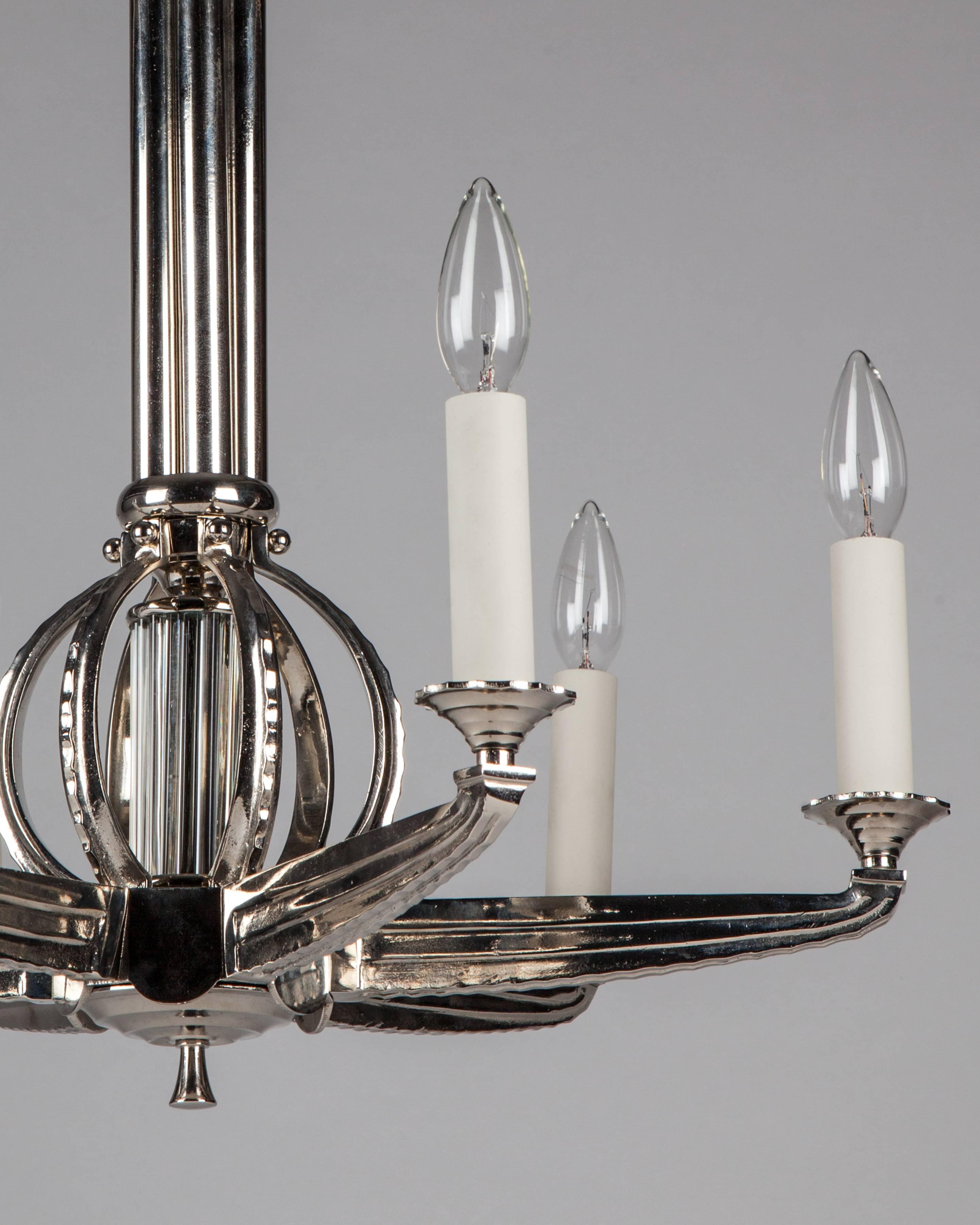 AHL4065
A vintage six-light German chandelier with a reeded nickel and glass rod body and fluted arms. In a polished nickel finish. Due to the antique nature of this fixture, there may be some nicks or imperfections in the
