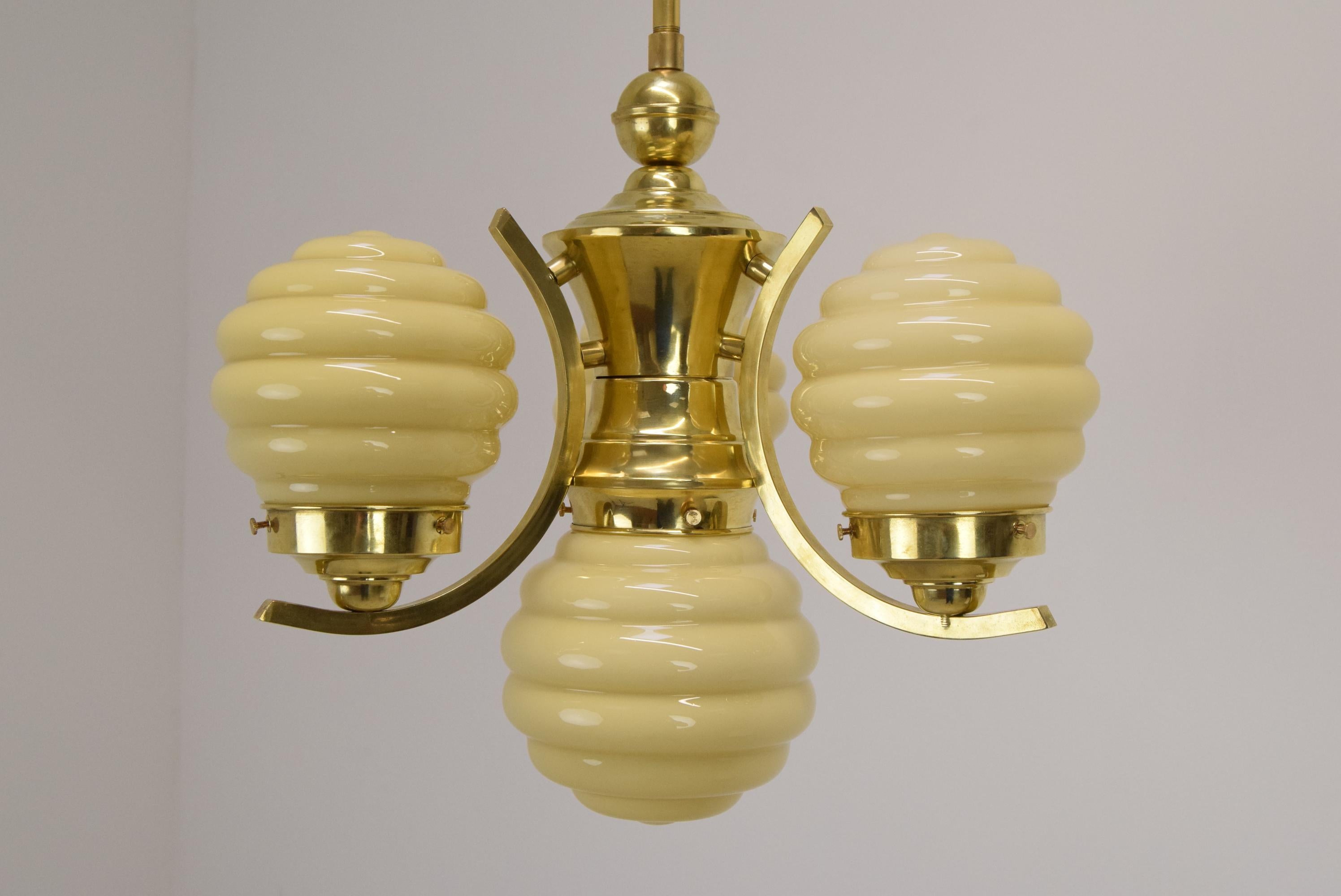 Made of glass, brass
4xE27 or E26 bulb
The Chandelier was completely disassembled and cleaned
With aged patina
It is equipped 
with a new electrical installation
US wiring compatible
Good original condition.
