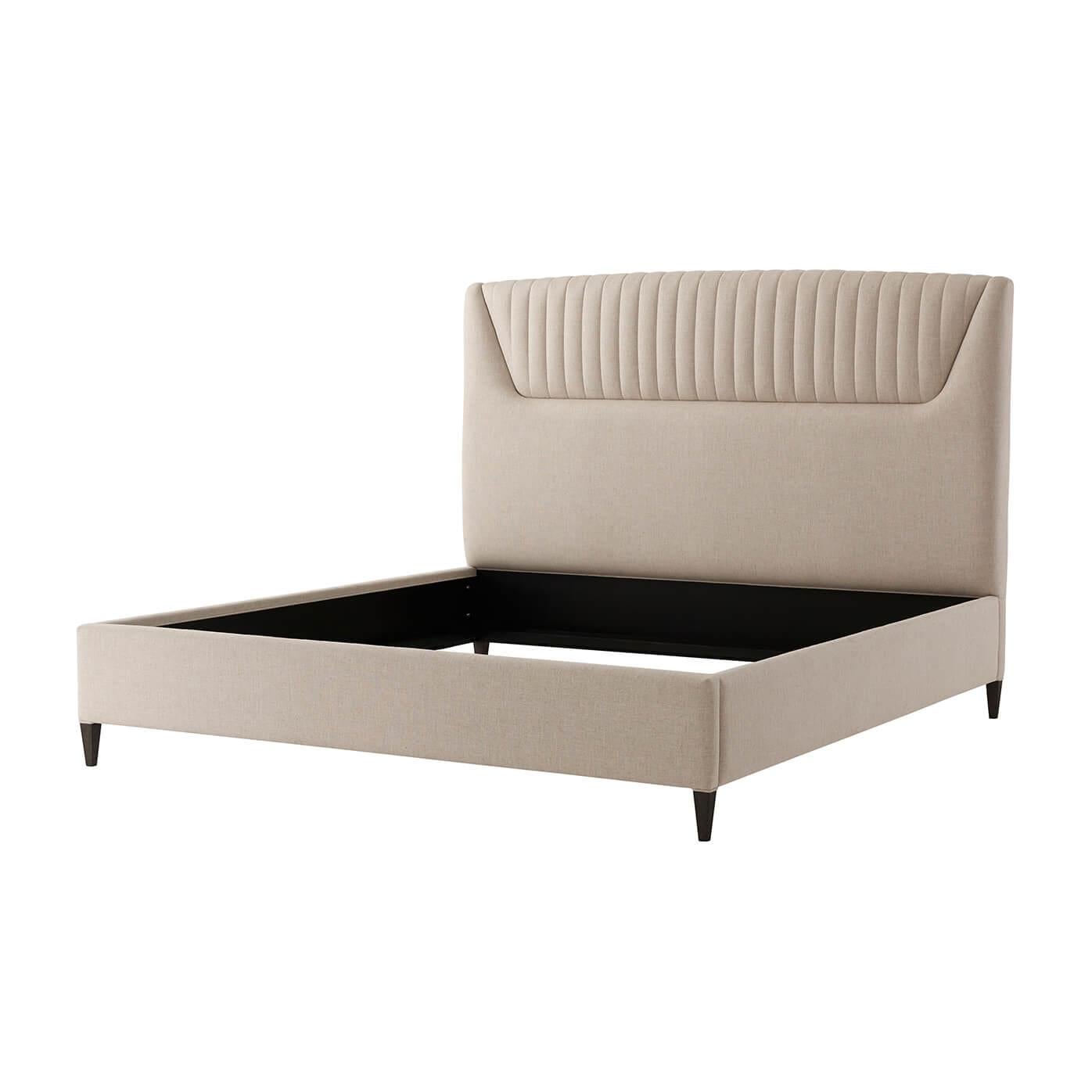 A modern Art Deco style king size bed with an upholstered headboard having a comb channeled centered panel, upholstered side rails and raised on square tapered legs.

Dimensions: 81.75