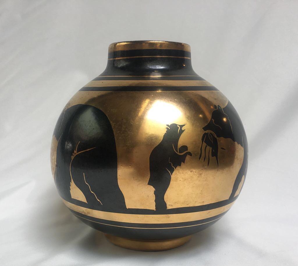Charles Catteau's gazed earthenware / faïence vase decorated with black bears and cubs on a gold background.
Stamp Boch La Louviere and numbered under the vase.
Measures: Height 23 cm diameter 22cm,
circa 1930.